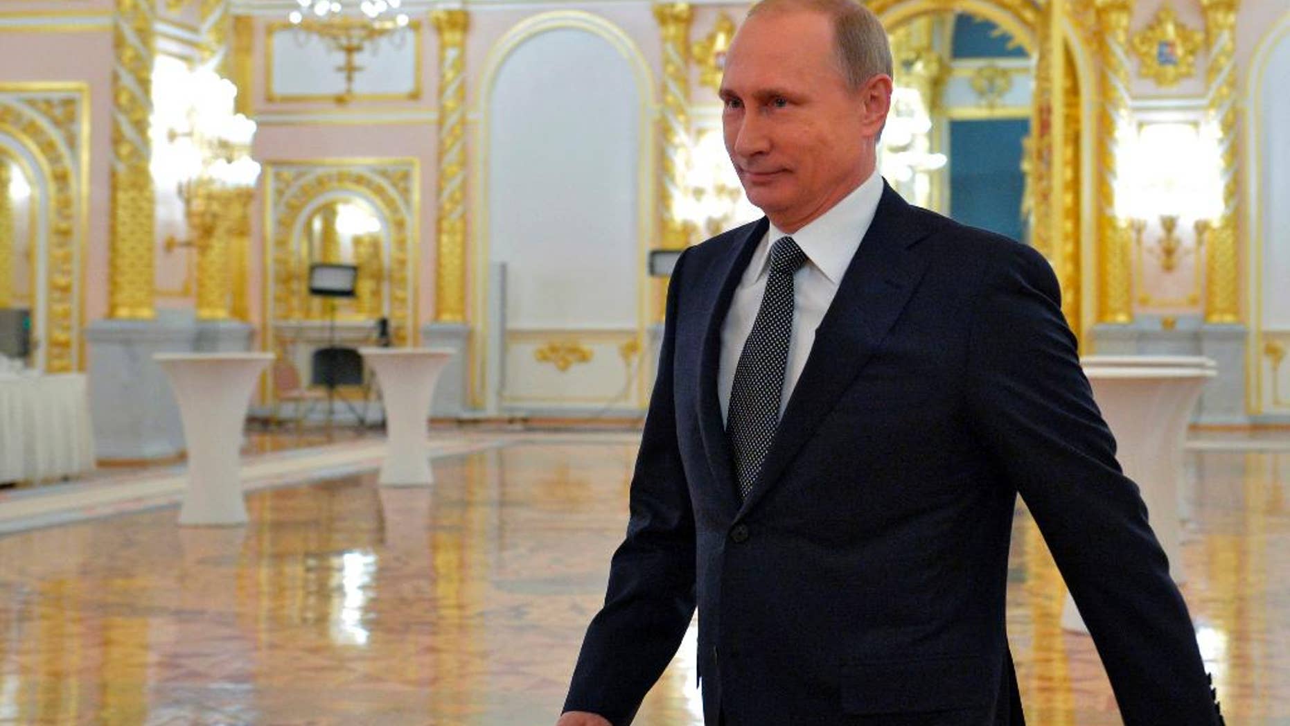 Russian President Vladimir Putin arrives to give his annual state of the nation address in the Kremlin in Moscow, Russia, on Thursday, Dec. 4, 2014. Russian President Vladimir Putin has defended the Kremlin's aggressive foreign policy, saying the actions are necessary for his country's survival. (AP Photo/RIA-Novosti, Alexei Druzhinin, Presidential Press Service)
