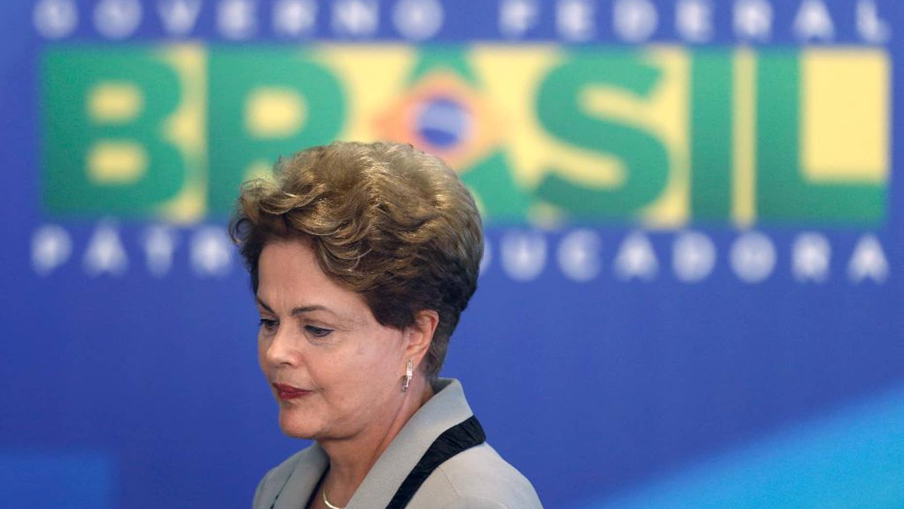 Brazil's President Dilma Rousseff leaves at the end of a government ceremony at the Planalto presidential palace in Brasilia, Brazil, Monday, March 16, 2015. Massive protests calling for Rousseff's impeachment on Sunday have narrowed her options to fend off political and economic crises, but her ouster remains highly unlikely, analysts said Monday. (AP Photo/Eraldo Peres)