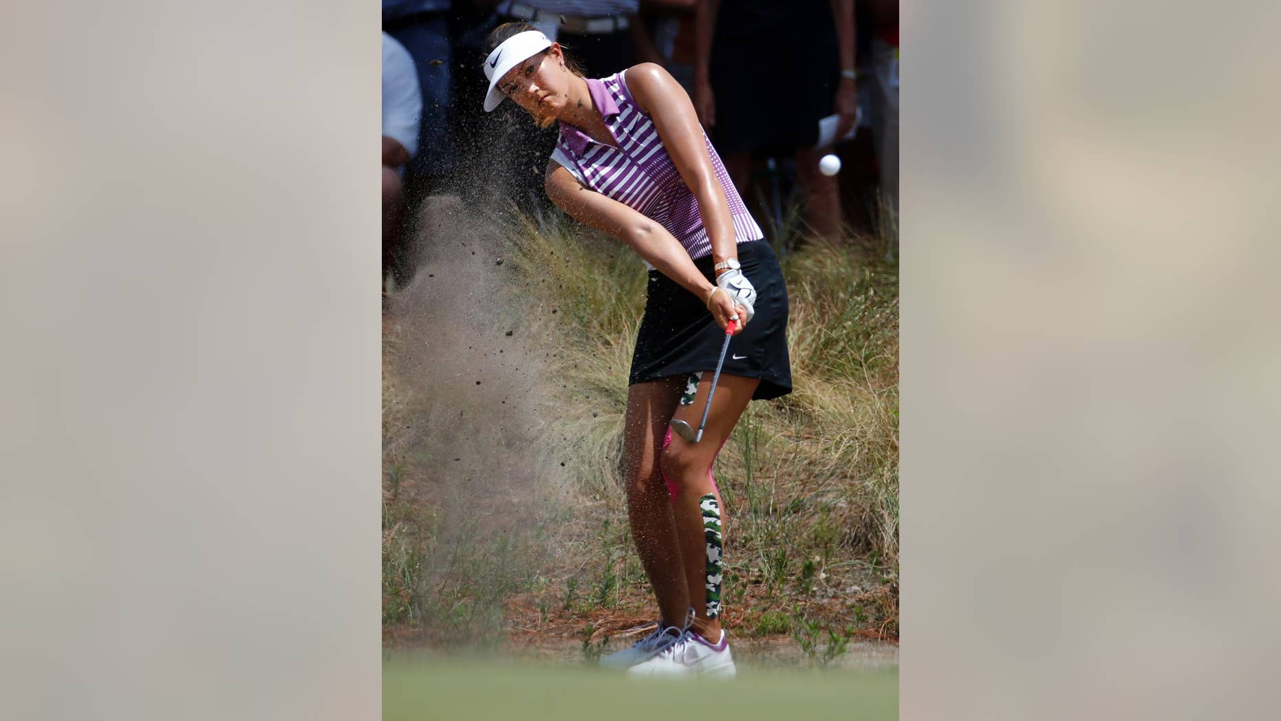 Michelle Wie chips to the seventh hole during the third round of the U.S. Women's Open golf tournament in Pinehurst, N.C., Saturday, June 21, 2014. (AP Photo/John Bazemore)