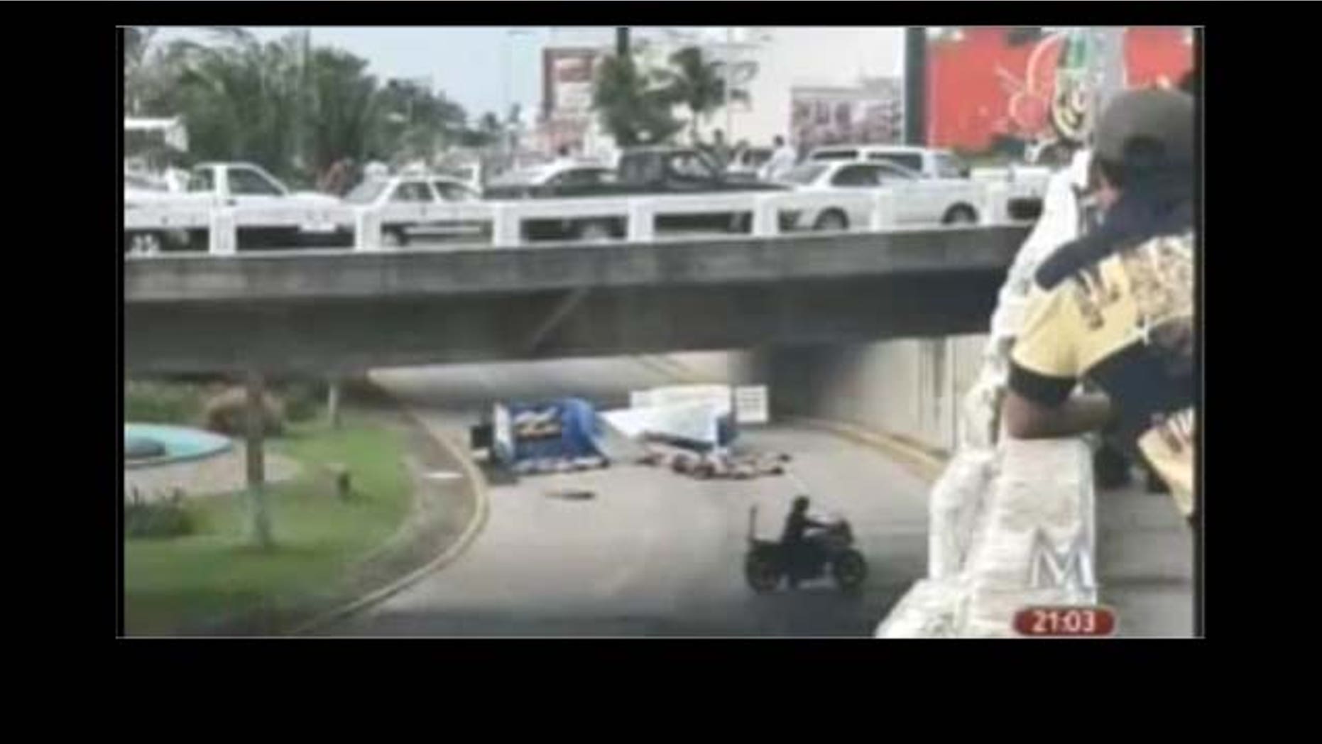 Sep. 20: A screenshot from Milenio TV in Mexico of the 35 bodies dumped in the middle of traffic in a busy road in the downtown of Boca del Rio.