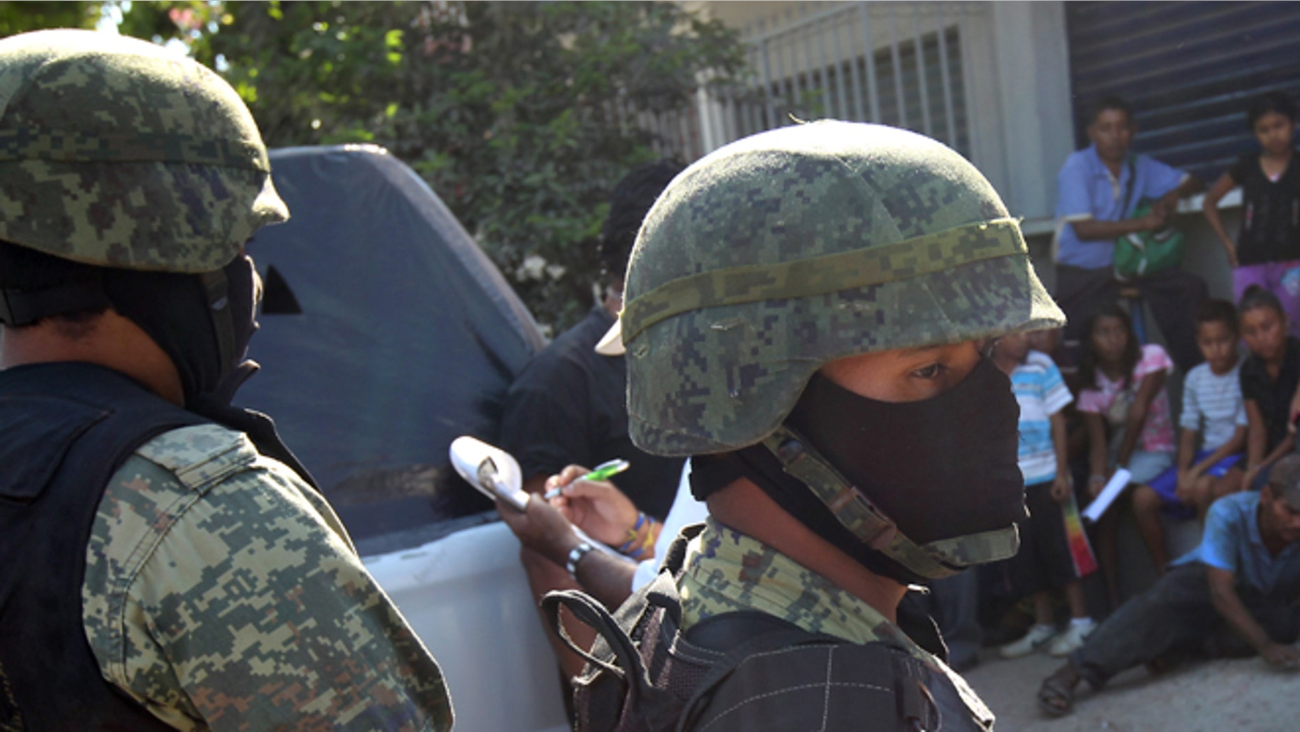 ACAPULCO, MEXICO - MARCH 03: Mexican marines stand guard at the site of a suspected drug-related execution on March 3, 2012 near Acapulco, Mexico. Drug violence has surged in the coastal resort in the last year, making Acapulco the second most deadly city in Mexico after Juarez. One of Mexico's top tourist destinations, Acapulco has suffered a drop in business, especially from foreign tourists, due to the violence. Toursim accounts for about 70 percent of the economy of Acapulco's state of Guerrero and 9 percent of Mexico's economy. (Photo by John Moore/Getty Images)