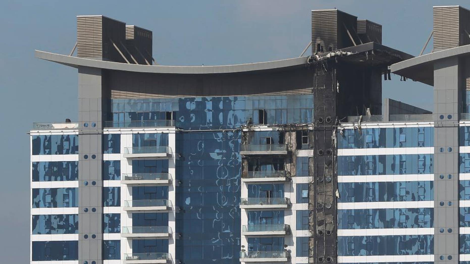 The burned elevation of one of the towers at the Oceana complex is seen in Dubai, United Arab Emirates, Tuesday, Dec. 13, 2016. Firefighters in Dubai have put out a fire that broke out on one of Dubai's palm-shaped island, the latest in a string of blazes to race up multi-story buildings in the skyscraper-packed city. Dubai's government media office said Tuesday that the late-night fire was completely extinguished with no injuries reported. (AP Photo/Kamran Jebreili)