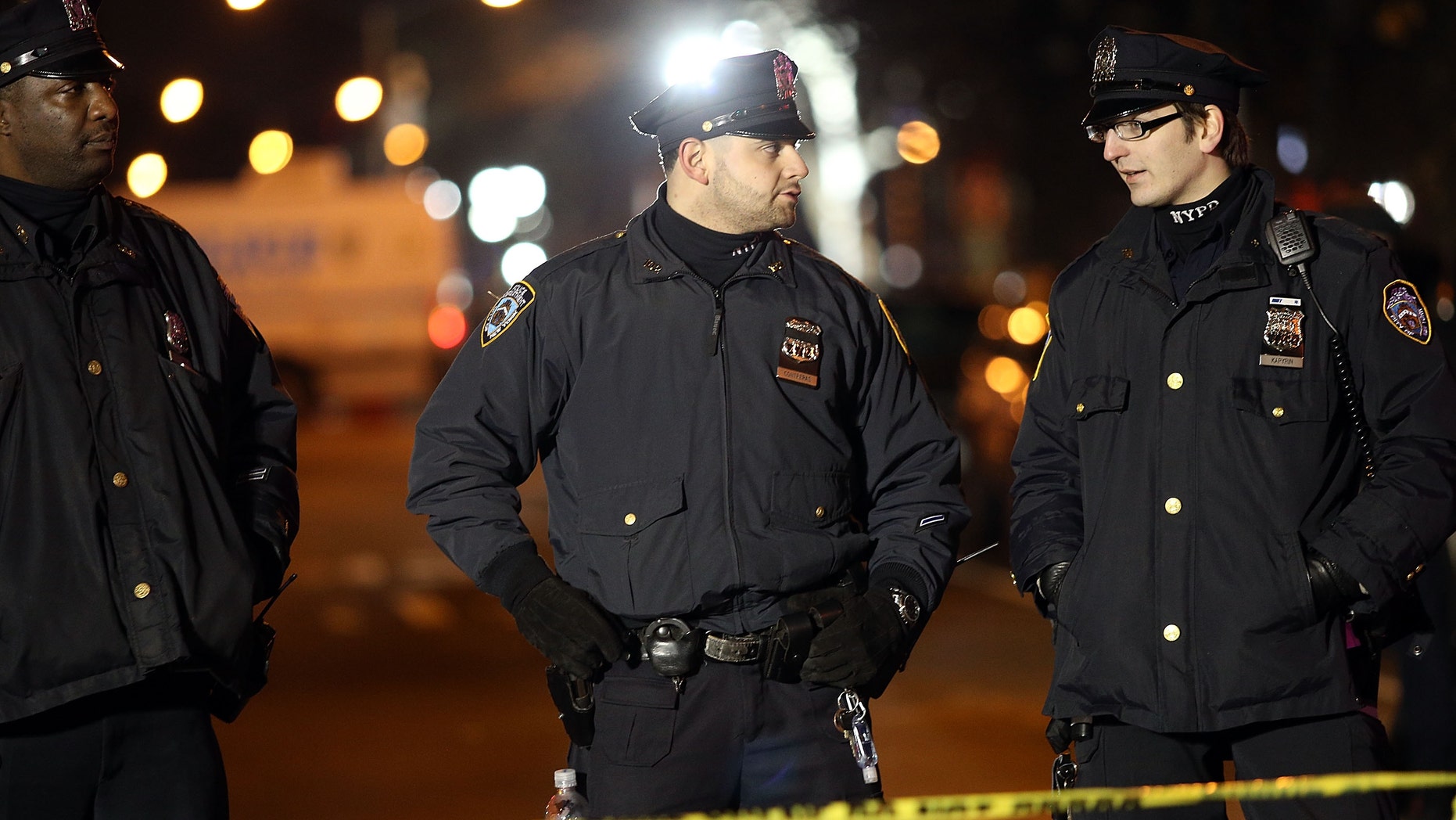 NEW YORK, NY - DECEMBER 20: The scene at a shooting where two New York City police officers were killed execution style Saturday afternoon as they sat in their marked police car on a Brooklyn street corner
> on December 20, 2014 in New York City. The suspect, who killed his girlfriend in Baltimore earlier in the day, was apparently motivated by the deaths of Eric Garner and Michael Brown. (Photo by Spencer Platt/Getty Images)
