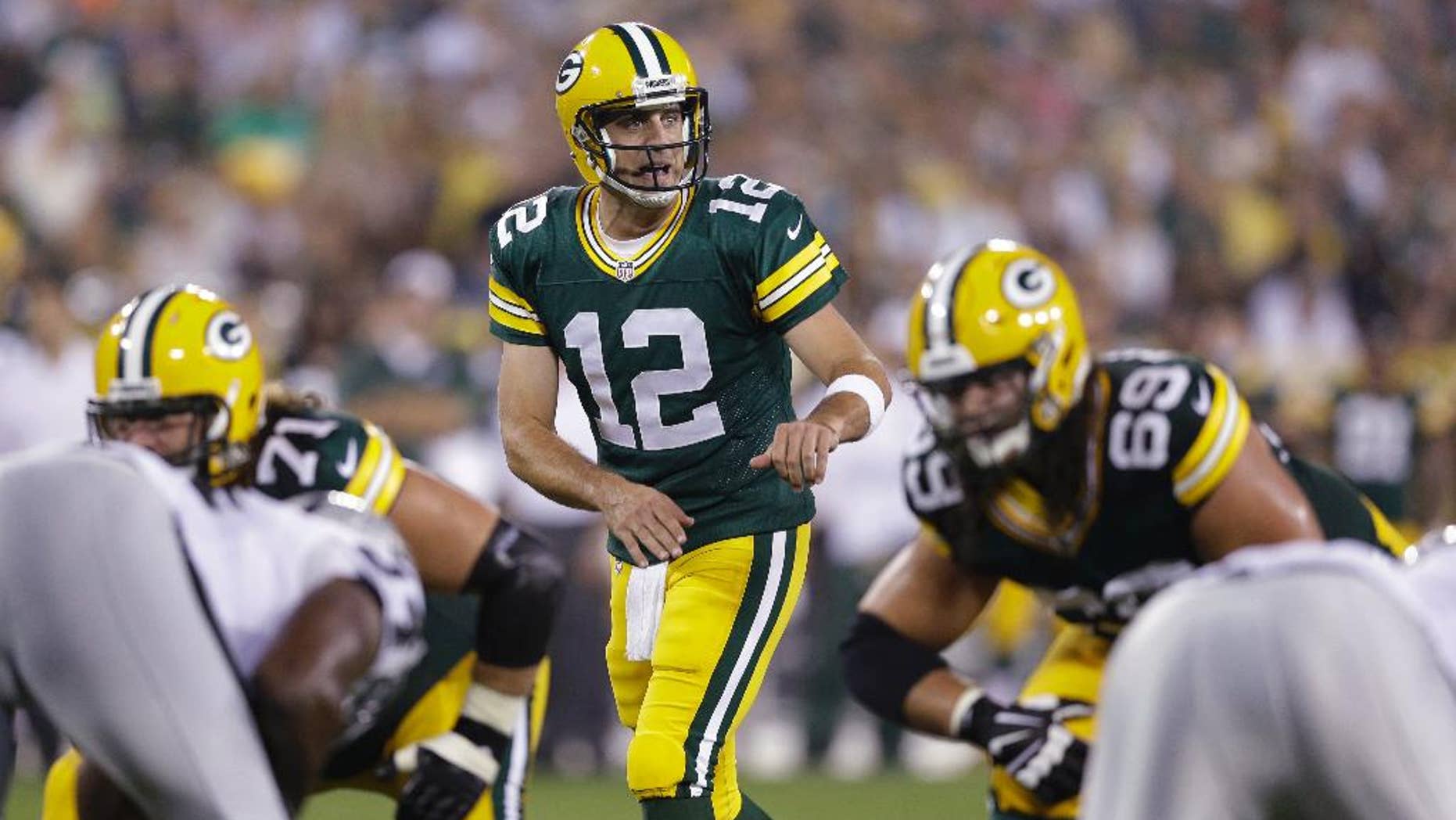 In this Aug. 22, 2014, photo, Green Bay Packers quarterback Aaron Rodgers approaches the line of scrimmage during the first half of an NFL preseason football game against the Oakland Raiders in Green Bay, Wis. Rodgers' first start at Seattle is making a lot of fantasy football owners squeamish. (AP Photo/Morry Gash)