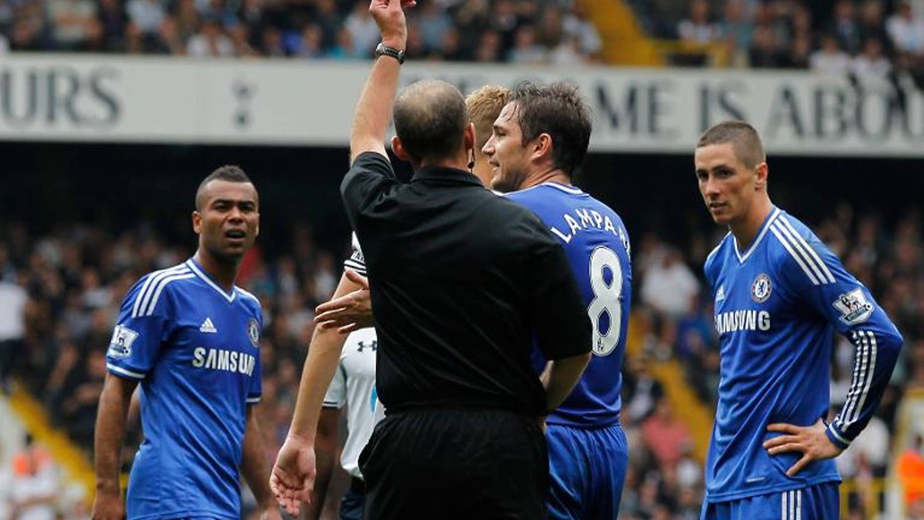 Chelsea's Spanish striker Fernando Torres (right) is shown the red card for a second bookable offence during a match with Tottenham Hotspur at White Hart Lane, September 28, 2013