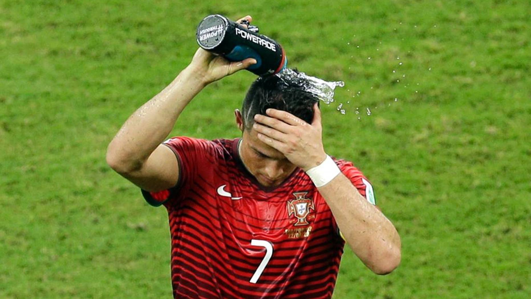 Portugal's Cristiano Ronaldo pours water over his head during the group G World Cup soccer match between the USA and Portugal at the Arena da Amazonia in Manaus, Brazil, Sunday, June 22, 2014. (AP Photo/Themba Hadebe)
