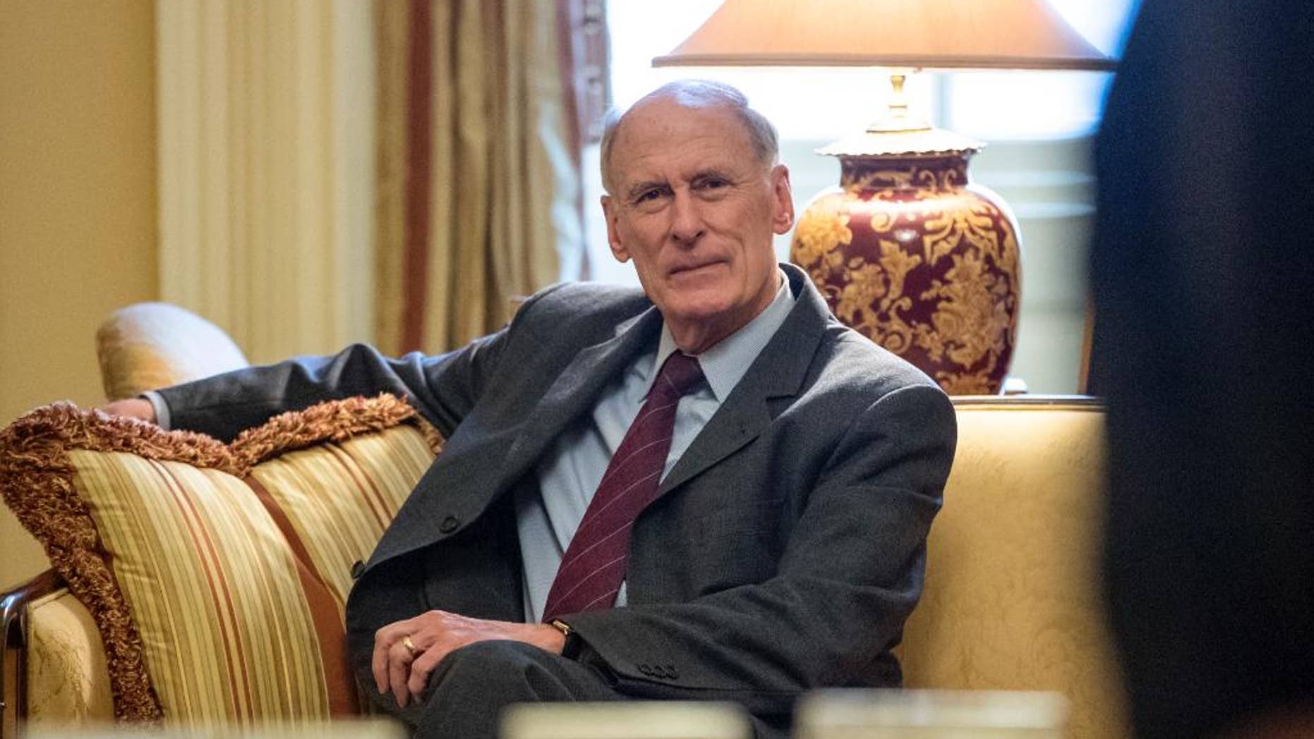 FILE - In this Jan. 23, 2017, file photo, National Intelligence Director nominee, former Indiana Sen, Dan Coats waits for the start of a meeting with Senate Majority Leader Mitch McConnell of Ky. on Capitol Hill in Washington. Partisan discord is seeping into House and Senate intelligence committee investigations of the Kremlin’s interference in the 2016 presidential election and whether President Donald Trump has ties to Russia. The issue will likely surface at the Feb. 28 Senate confirmation hearing for former Coats. (AP Photo/J. Scott Applewhite, File)