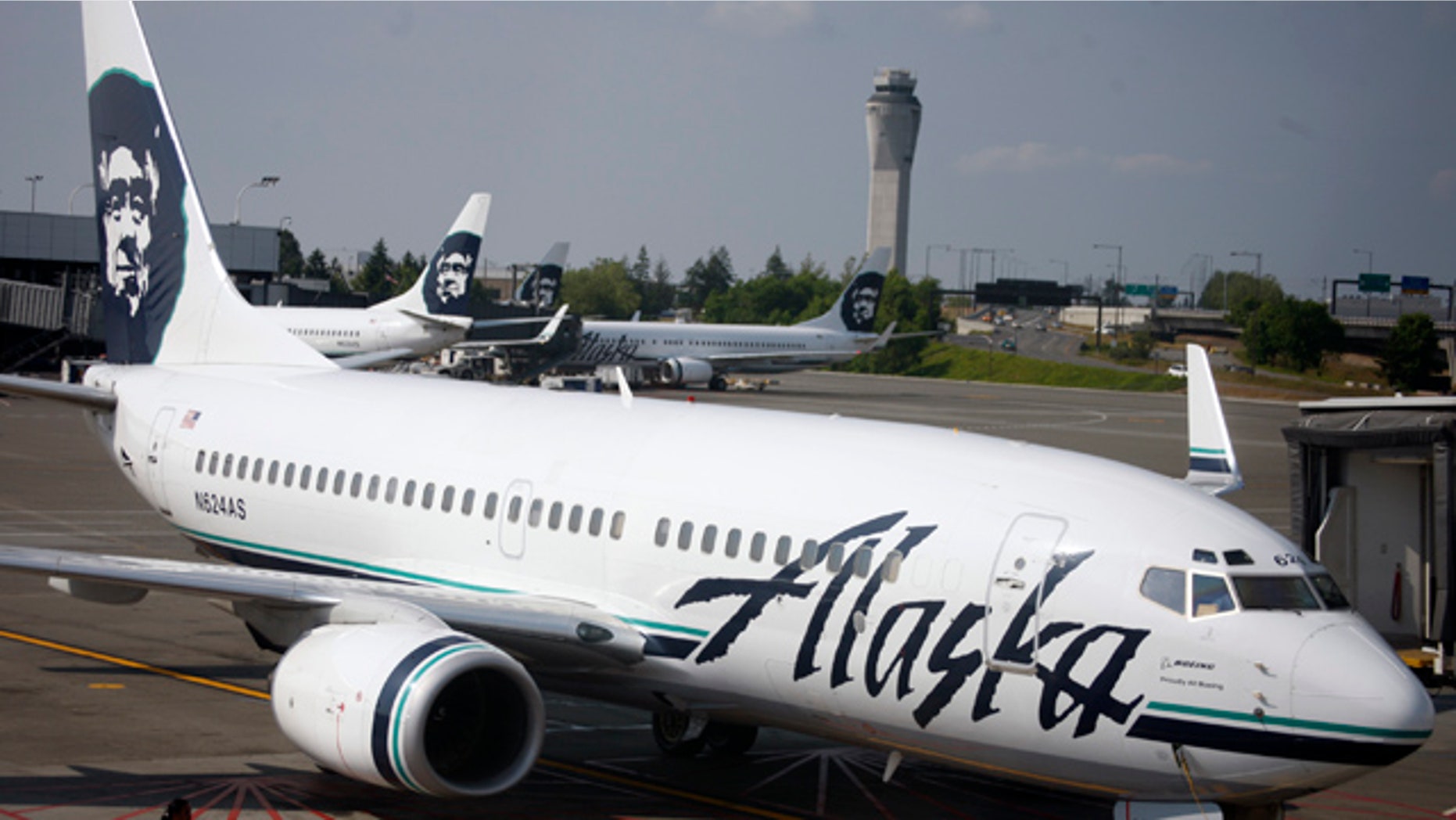 In this June 11, 2009 file photo, an Alaska Airlines airliner is pushed away from a gate at SeaTac Airport in SeaTac, Wash.
