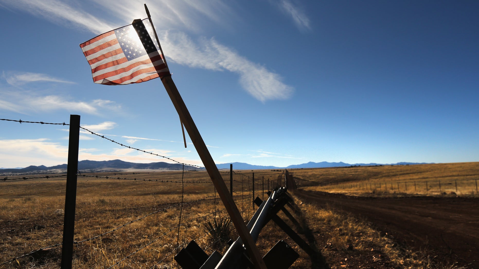 SONOITA, AZ - FEBRUARY 26: An American flag flies at the U.S.-Mexico border on February 26, 2013 near Sonoita, Arizona. The Federal government has increased the Border Patrol presence in Arizona, from some 1,300 agents in the year 2000 ro 4,400 in 2012. The apprehension of undocumented immigrants crossing into the U.S. from Mexico has declined during that time from 600,016 in 2000 to 123,000 in 2012. (Photo by John Moore/Getty Images)