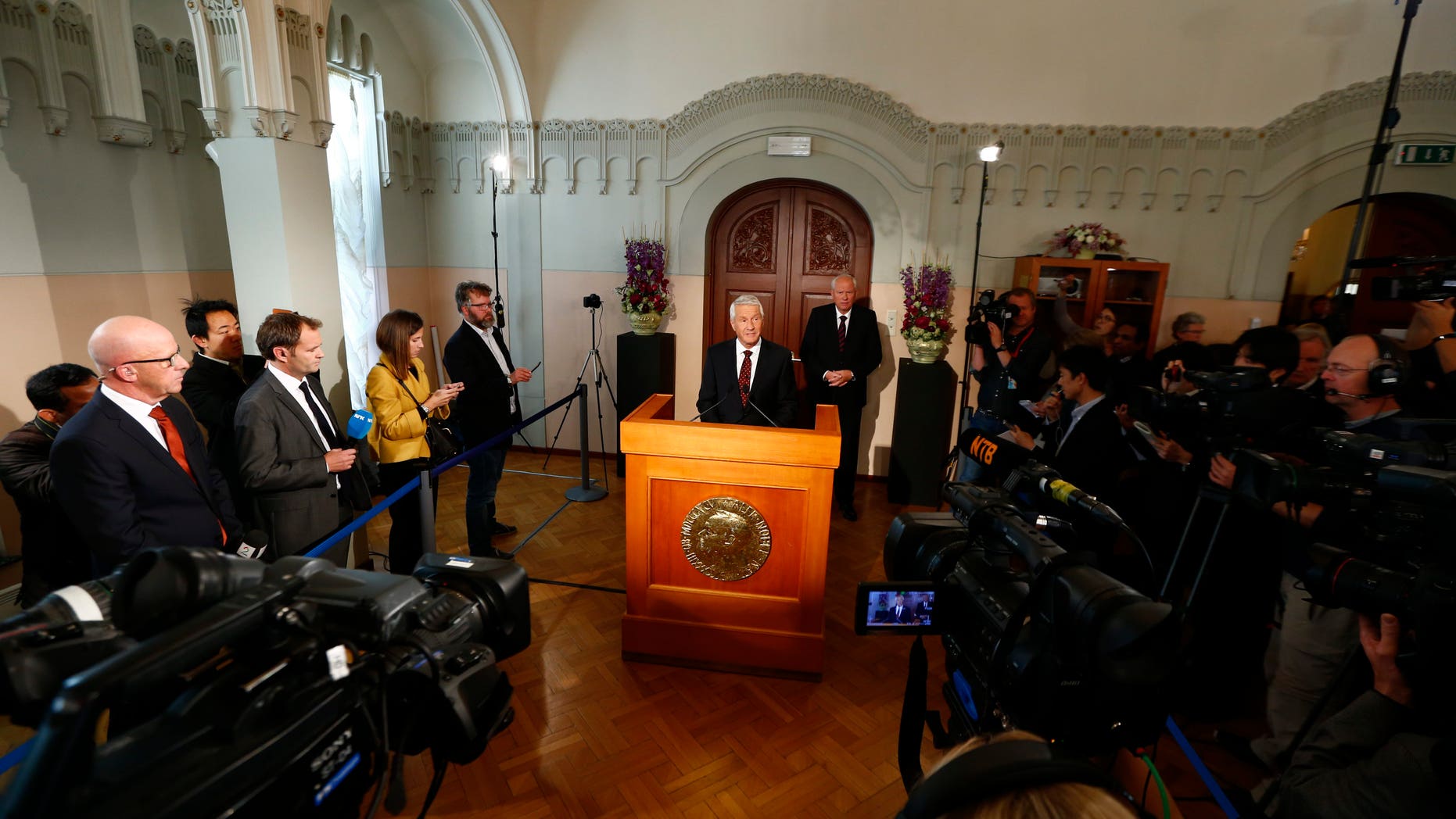 The chairman of the Norwegian Nobel Committee, Thorbjorn Jagland, centre, announces, the winner of the Nobel Peace Prize, at the Nobel Institute, in Oslo, Friday Oct. 11, 2013. The Organization for the Prohibition of Chemical Weapons has won this year's Nobel Peace Prize, it was announced on Friday. The Norwegian Nobel Committee honored the Hague, Netherlands-based global chemical watchdog "for its extensive efforts to eliminate chemical weapons."(AP Photo/ NTB Scanpix, Heiko Junge) NORWAY OUT