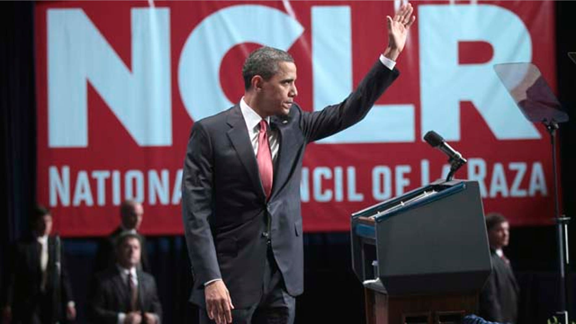 President Barack Obama waves as he prepares to walks off stage after delivering remarks at the National Council of La Raza (NCLR) annual conference luncheon in Washington, Monday, July 25, 2011. (AP Photo/Pablo Martinez Monsivais)