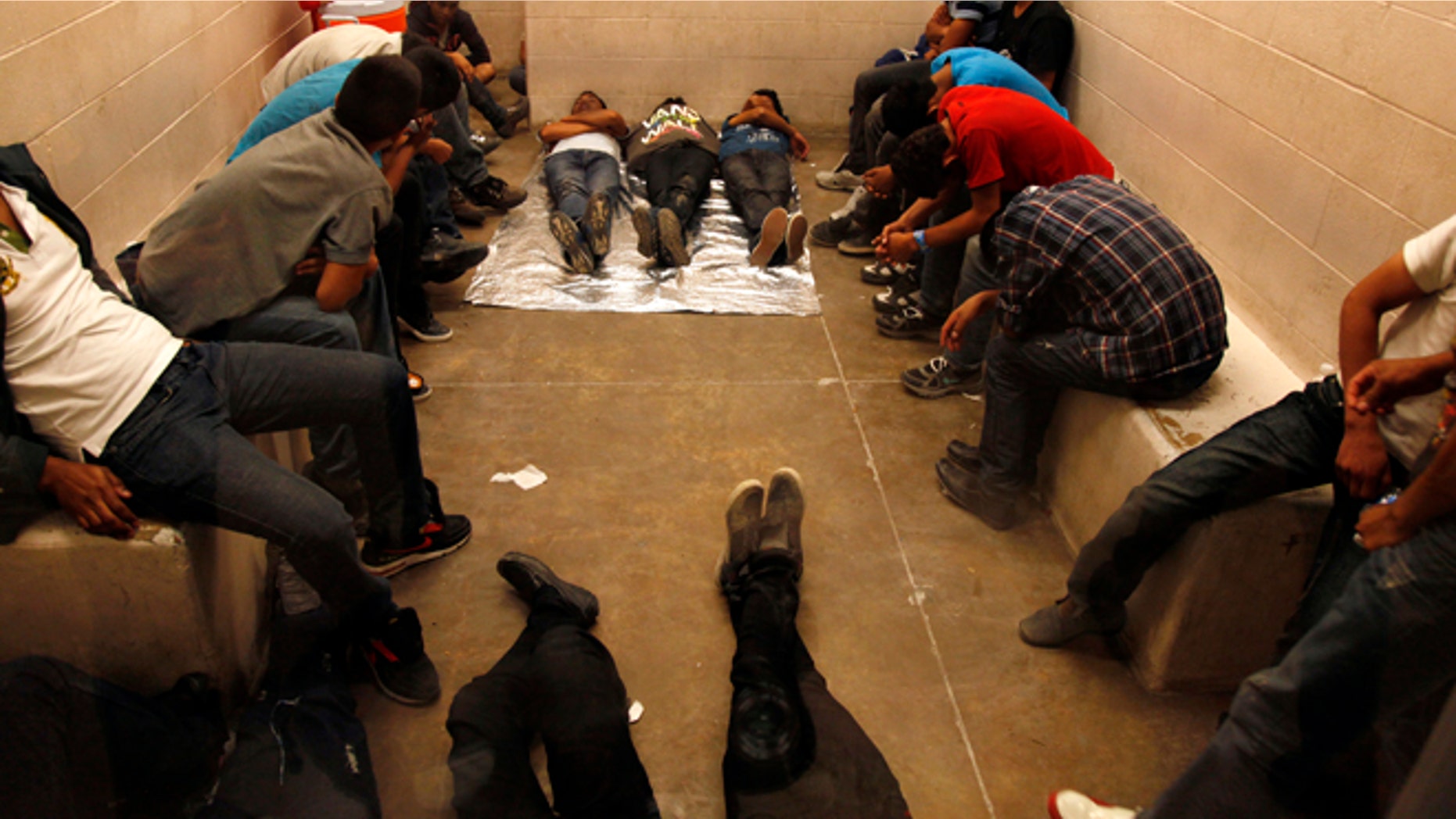 MCALLEN, TX. --TUESDAY, JULY 15, 2014 -- Immigrants who have been detained while crossing the border are held inside the McAllen Border Patrol Station in McAllen, Texas, Tuesday July 15, 2014. More than 350 detainees were being held on Tuesday, July 15, 2014, at the station. A solution for the growing crisis of tens of thousands of unaccompanied children showing up at the U.S.-Mexico border is looking increasingly elusive with three weeks left before Congress leaves Washington for an annual August recess. (AP Photo/Los Angeles Times, Rick Loomis, Pool)