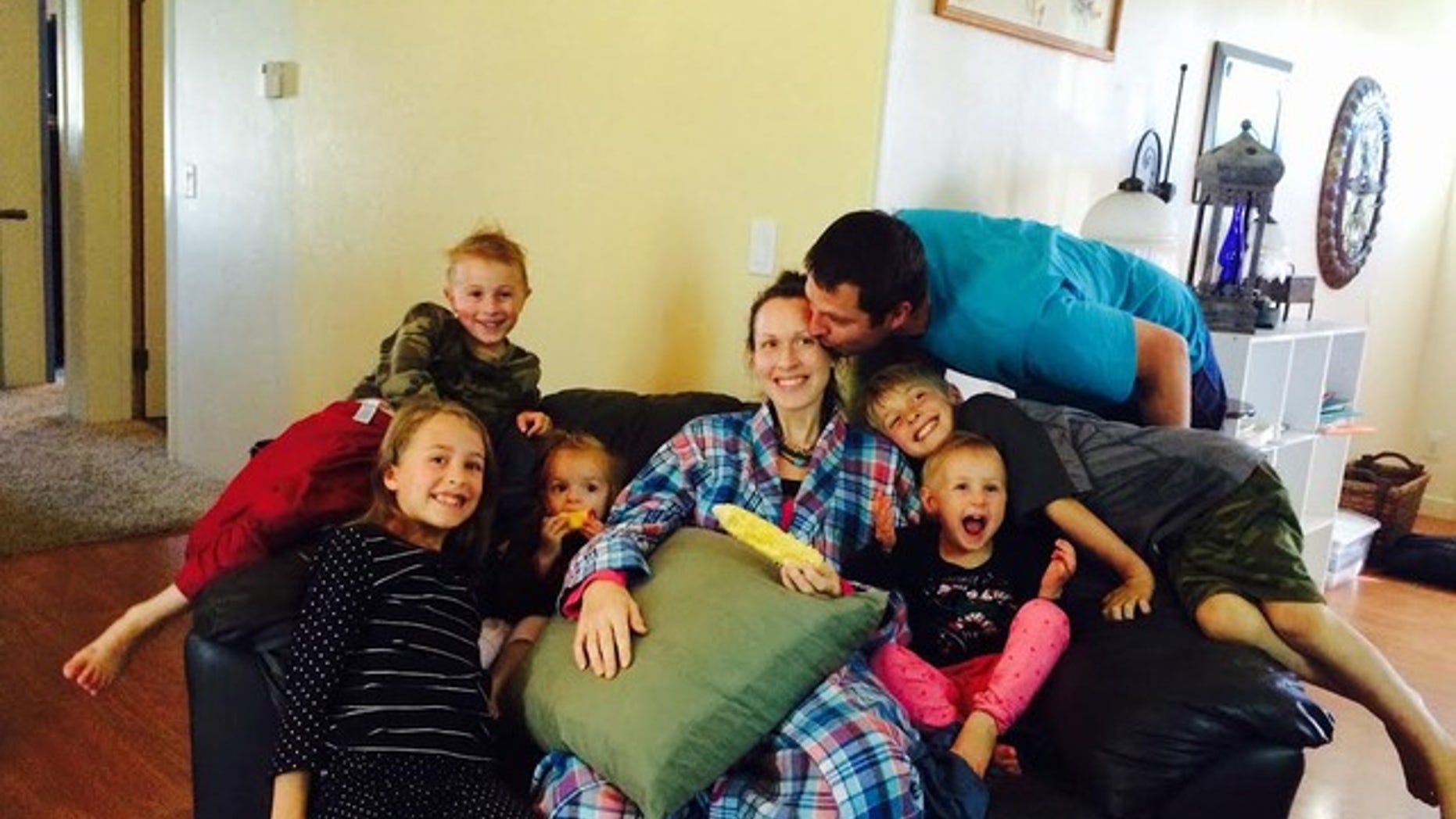 This photo shows Kathy Taylor returning home with her children and husband Nate.