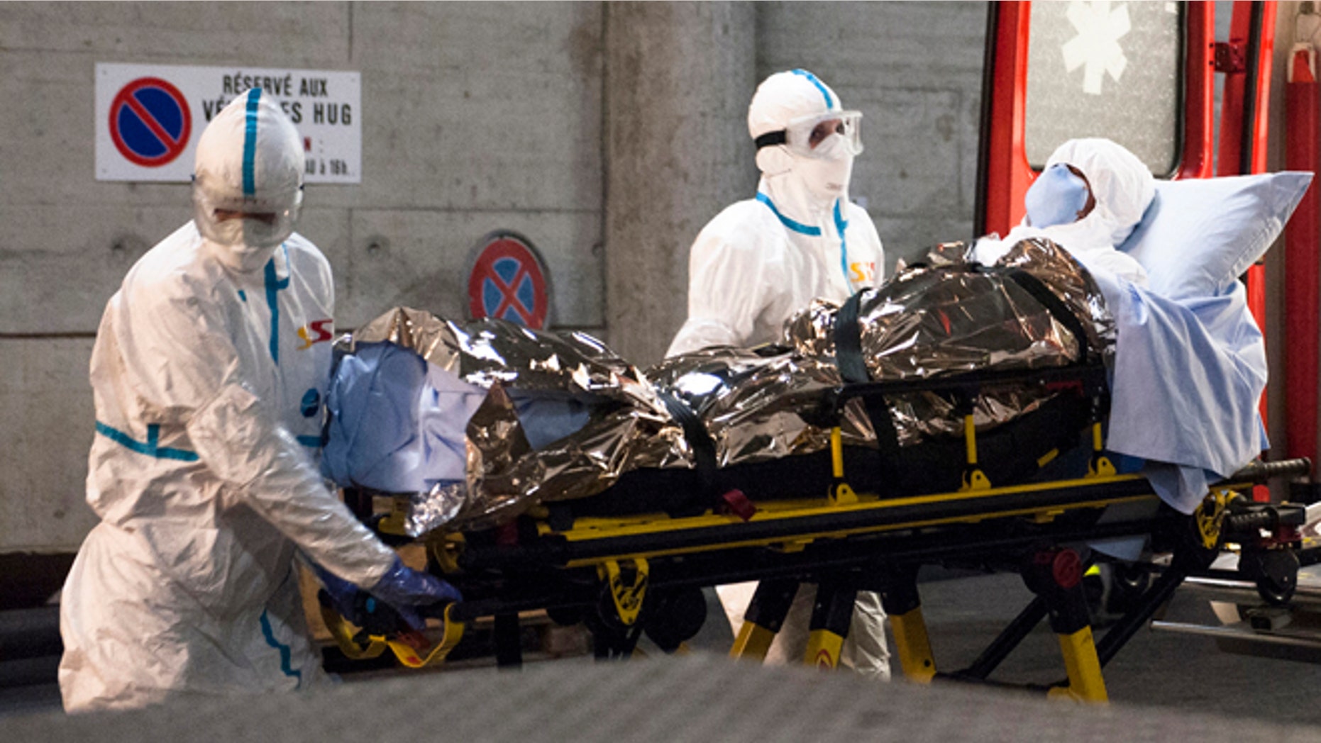 In this photo provided by the Geneva University Hospital (HUG), Cuban doctor Felix Baez Sarria, who contracted Ebola in Sierra Leone, arrives on a gurney at the Geneva University Hospital in Geneva, Switzerland, Friday, Nov. 21, 2014. Baez, a member of the 165-person medical team Cuba sent to Sierra Leone to help with the Ebola outbreak, caught the disease when he rushed to help a patient who was falling over. (AP Photo/Julien Gregorio, Geneva University Hospital) MANDATORY CREDIT, NO ARCHIVE