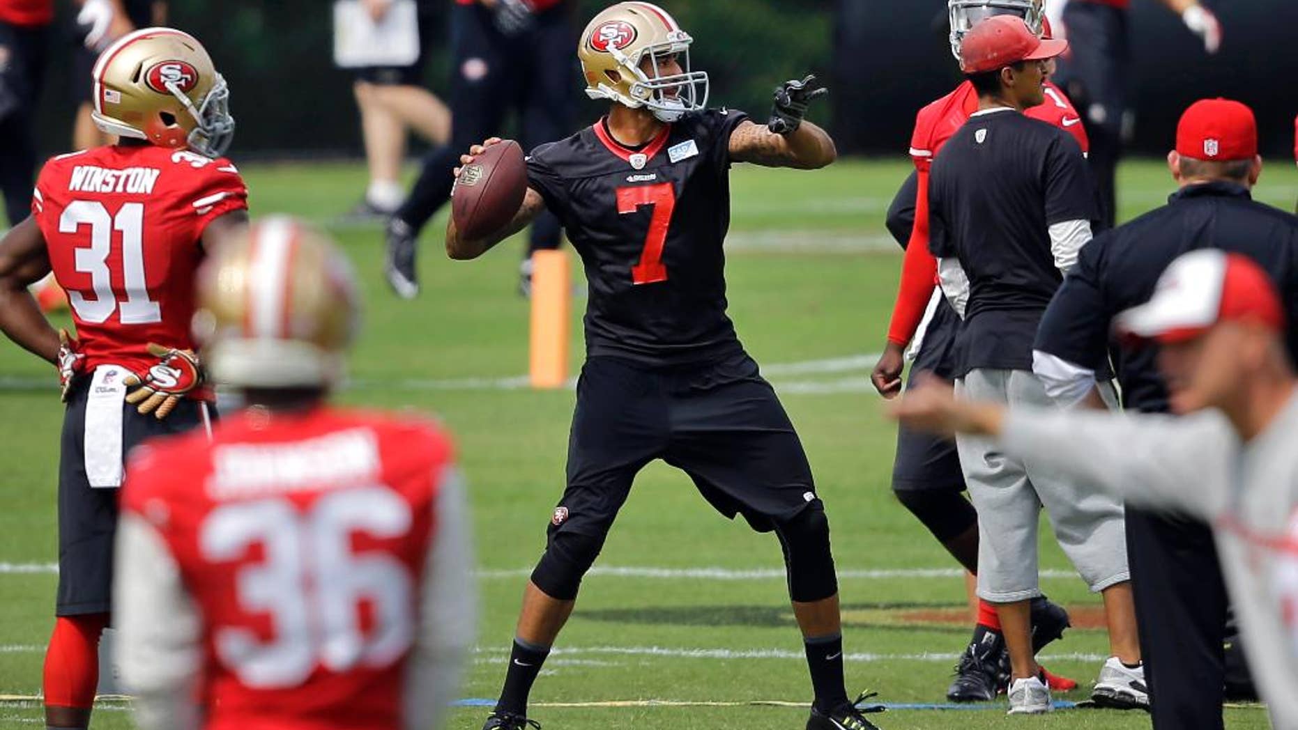 San Francisco 49ers quarterback Colin Kaepernick (7) throws a pass to a receiver during an NFL football training camp practice, Monday, Aug. 11, 2014, in Owings Mills, Md. (AP Photo/Patrick Semansky)