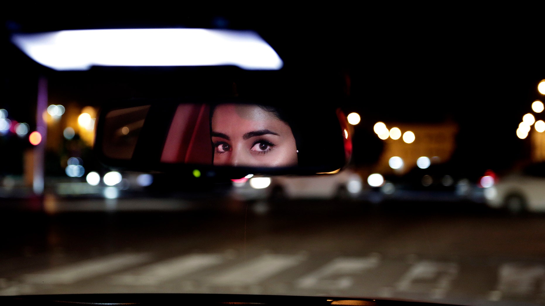 FILE - In this Sunday, June 24, 2018 file photo, Hessah al-Ajaji drives her car down the capital's busy Tahlia Street after midnight for the first time, in Riyadh, Saudi Arabia. Saudi women are driving freely for the first time after years of risking arrest if they dared to get behind the wheel. (AP Photo/Nariman El-Mofty, File)