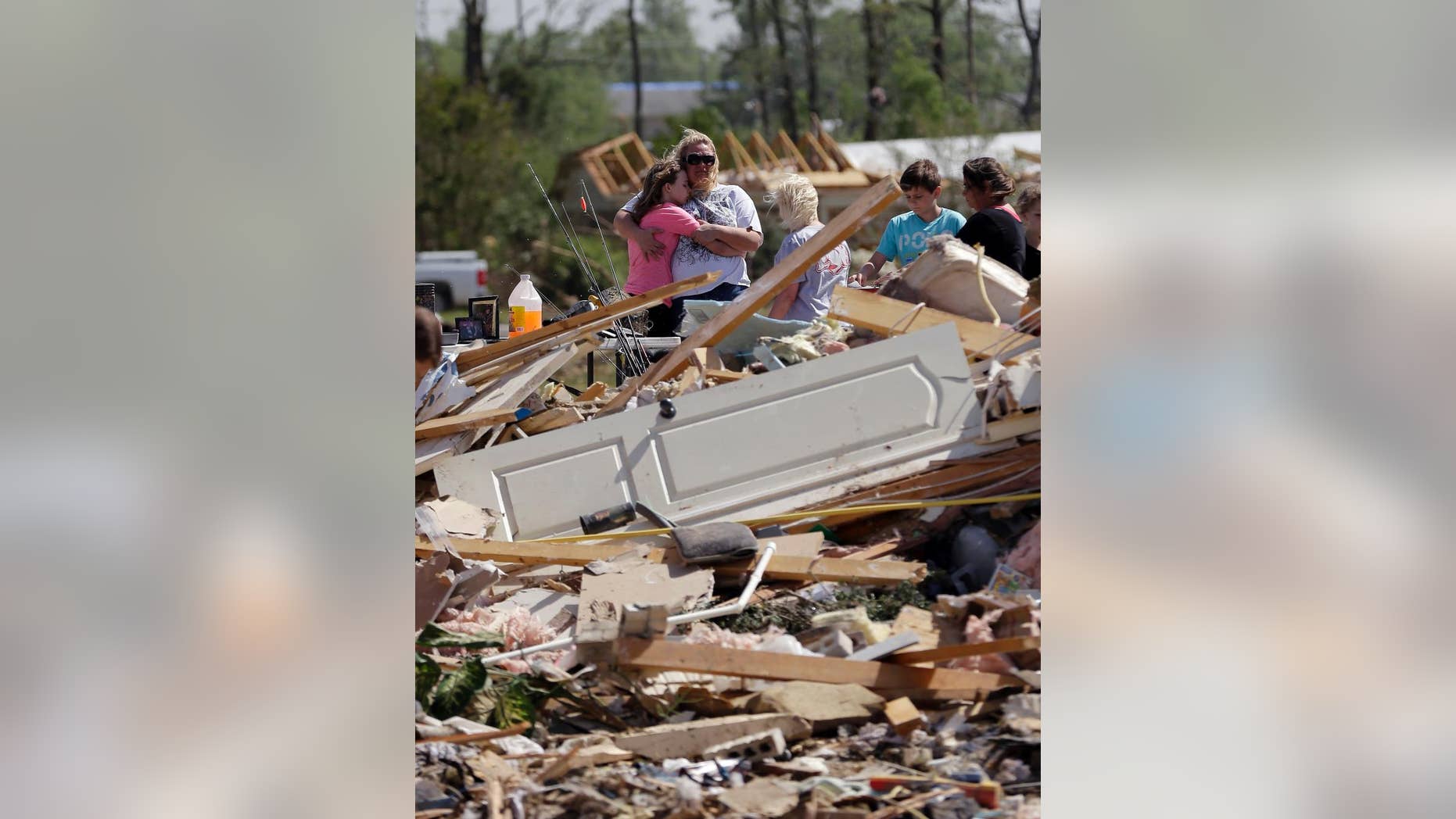 Residents and friends sift through debris after a tornado struck the area, Monday, April 28, 2014, in Vilonia, Ark. (AP Photo/Eric Gay)