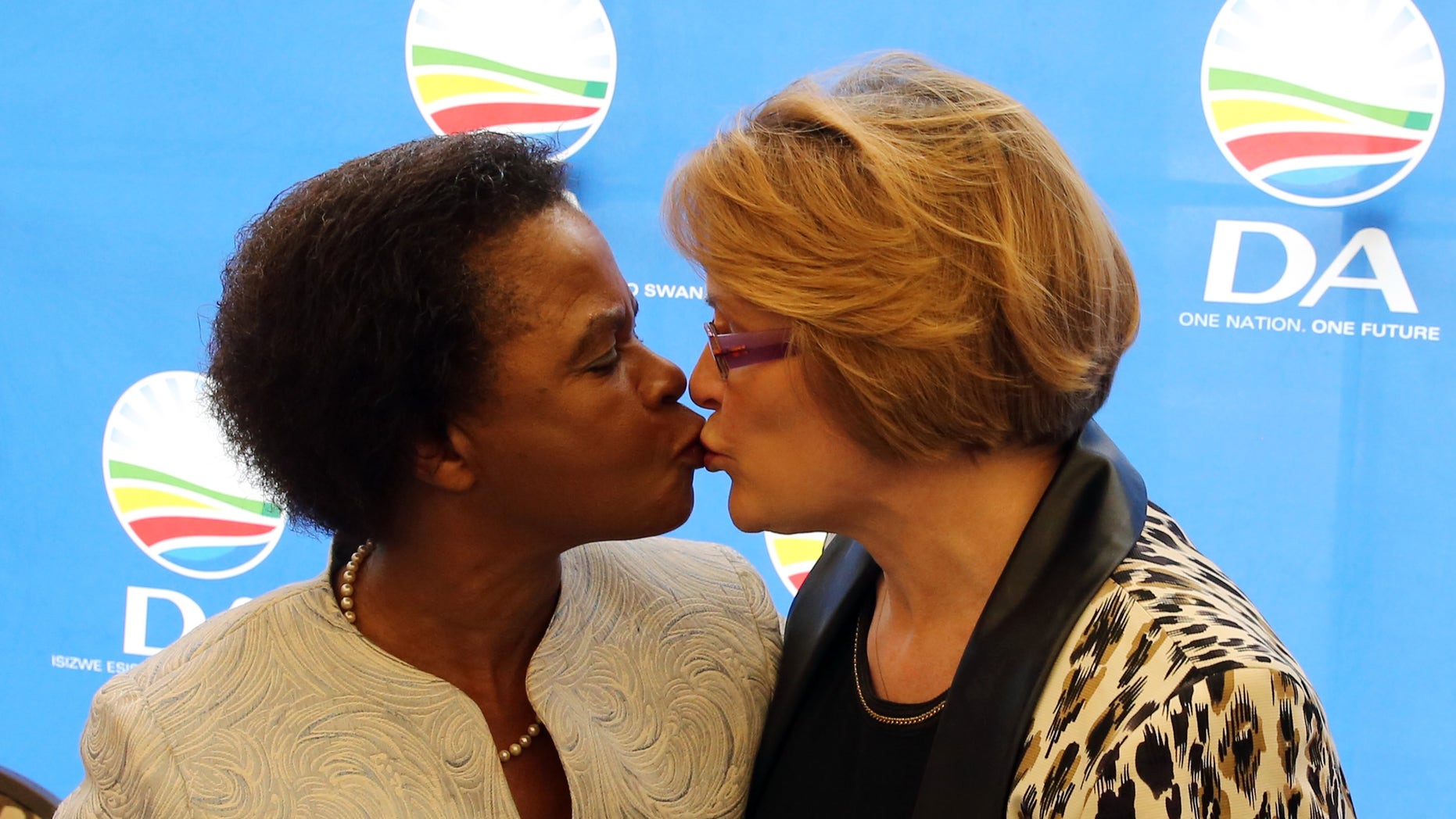 South African anti-apartheid activist Mamphela Ramphele, left, greets Helen Zille, right, the head of the South African Democratic Alliance political party during a press conference in Cape Town, South Africa, Tuesday, Jan. 28, 2014. The former anti-apartheid activist who was close to Steve Biko and was a World Bank executive merged her party Tuesday with South Africa's main opposition party, the Democratic Alliance, and will be its presidential candidate, challenging the ruling African National Congress whose popularity has eroded amid corruption scandals and other problems. (AP Photo/ Nardus Engelbrecht)