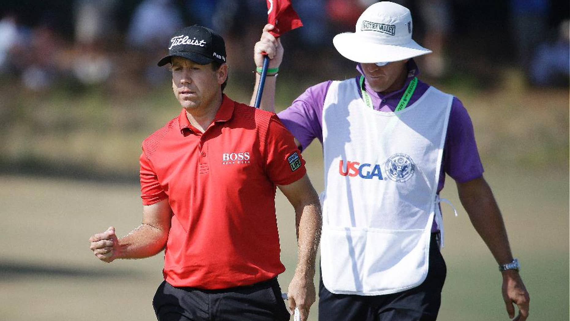 Erik Compton reacts to his birdie on the fifth hole during the final round of the U.S. Open golf tournament in Pinehurst, N.C., Sunday, June 15, 2014. (AP Photo/David Goldman)