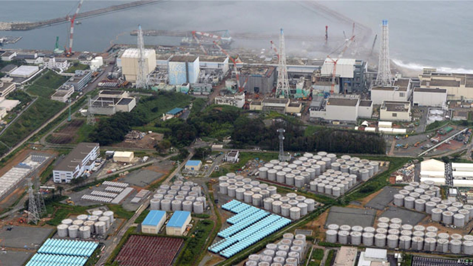 FILE - This Aug. 20, 2013 aerial file photo shows the Fukushima Dai-ichi nuclear plant at Okuma in Fukushima prefecture, northern Japan. Japan's nuclear regulator has upgraded the rating of a leak of radiation-contaminated water at its tsunami-wrecked nuclear plant to a "serious incident" on an international scale. (AP Photo/Kyodo News, File)