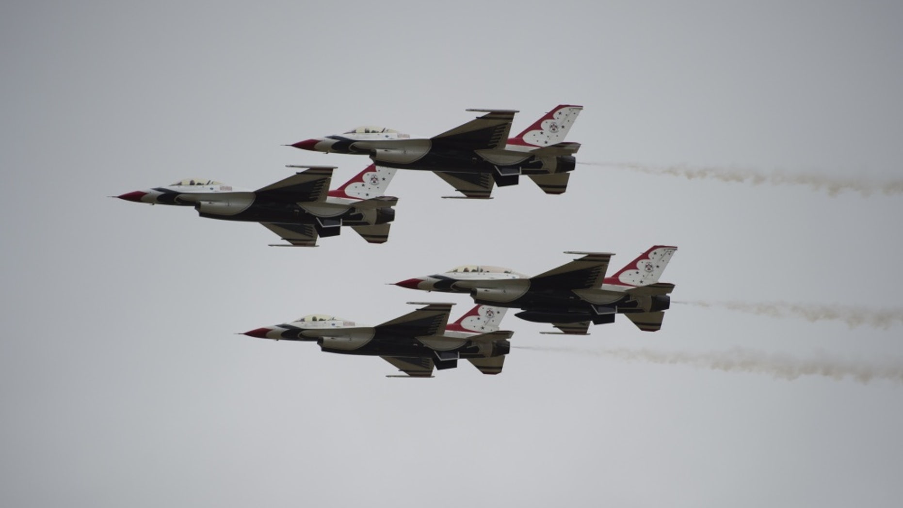 The U.S. Air Force Thunderbirds in their F-16s perform a maneuver.