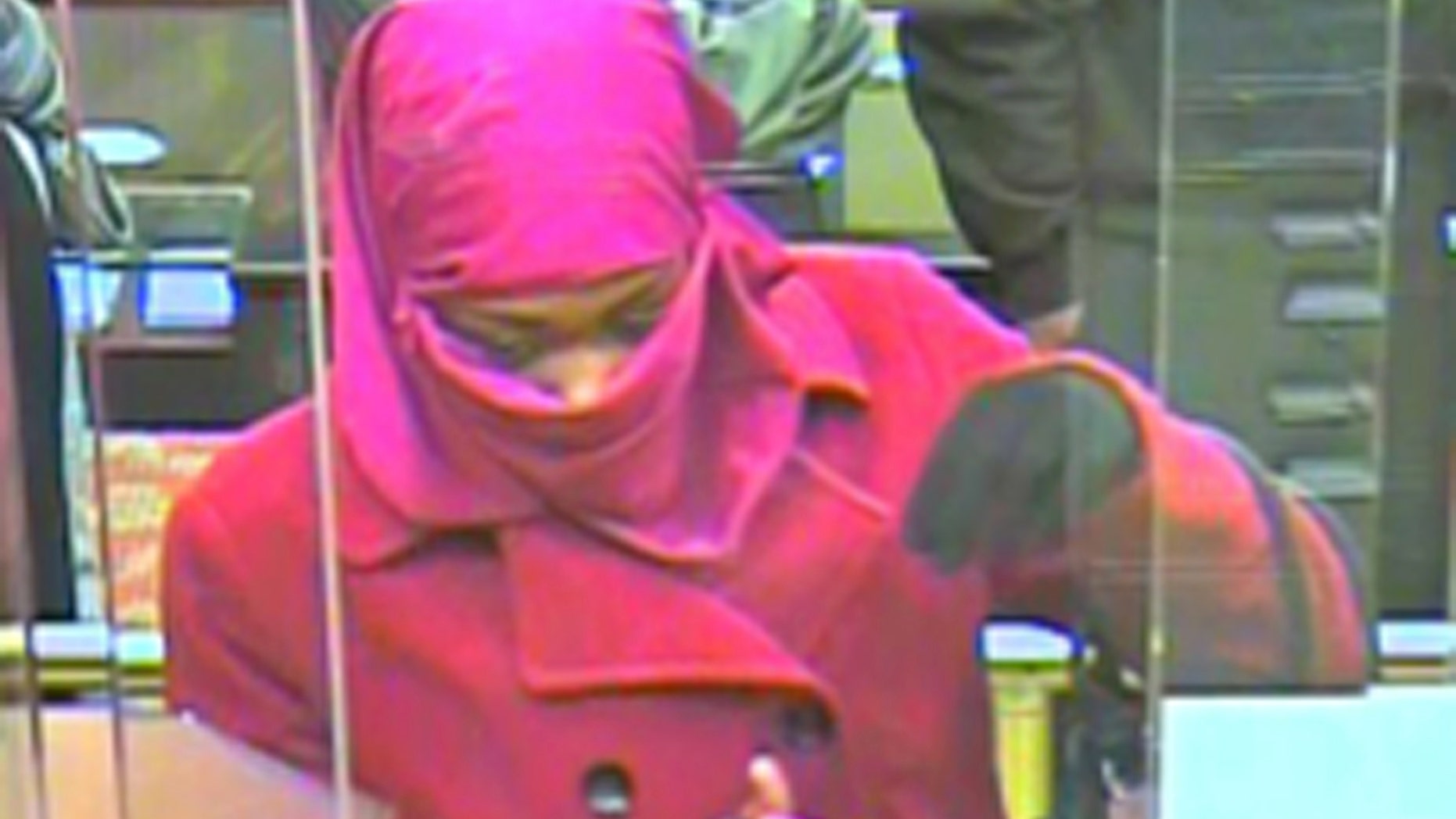 In this Monday, Dec. 2, 2013 surveillance photo, a woman appears inside a bank in Landover, Md. Prince George's County Police are looking for the woman who they say robbed the Capital One Bank on Annapolis Road in Landover. (AP Photo/Prince George's County Police Department)