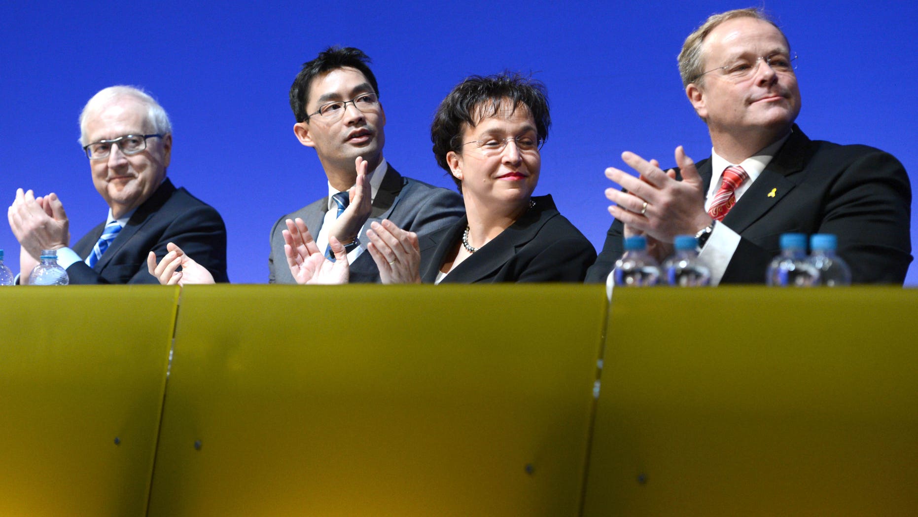 From left: Free Democratic Party (FDP) faction leader Rainer Bruederle. German economy minister, vice-chancellor and party chairman, Philipp Roesler, vice-chairwoman of the party, Birgit Homburger and development minister Dirk Niebel attend a meeting of the FDP in Stuttgart, southern Germany, Sunday, Jan. 6, 2013. Germany's embattled vice chancellor is battling to quell speculation about his leadership of the country's junior governing party, whose dire poll ratings are a complicating factor in Chancellor Angela Merkel's bid for re-election. Philipp Roesler, who's also Germany's economy minister, appealed to his pro-market Free Democratic Party on Sunday to show unity ahead of a state election in his home region of Lower Saxony on Jan. 20, an important political test ahead of national elections in September. (AP Photo/dpa/ Bernd Weißbrod)