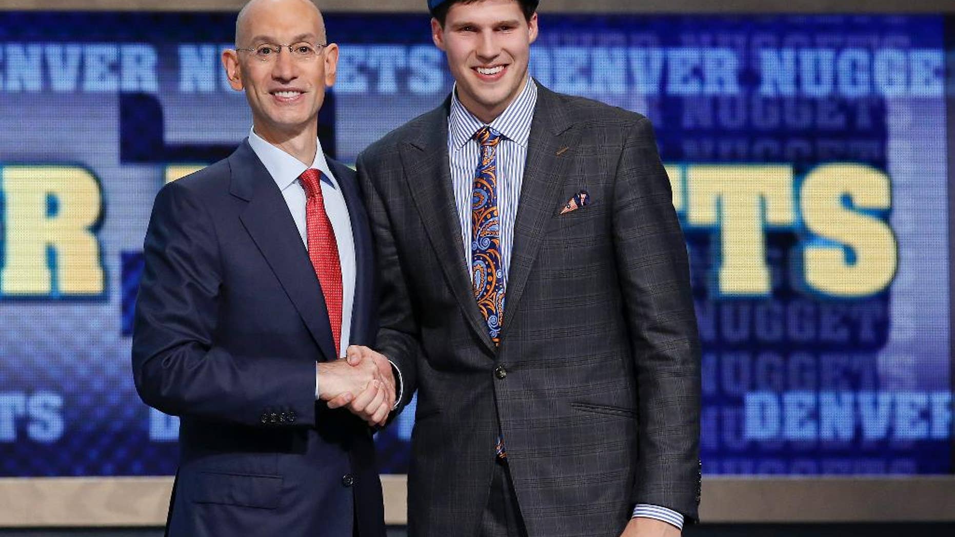 Creighton's Doug McDermott, right, poses for a photo with NBA Commissioner Adam Silver after being selected 11th overall by the Denver Nuggets during the 2014 NBA draft, Thursday, June 26, 2014, in New York. (AP Photo/Kathy Willens)