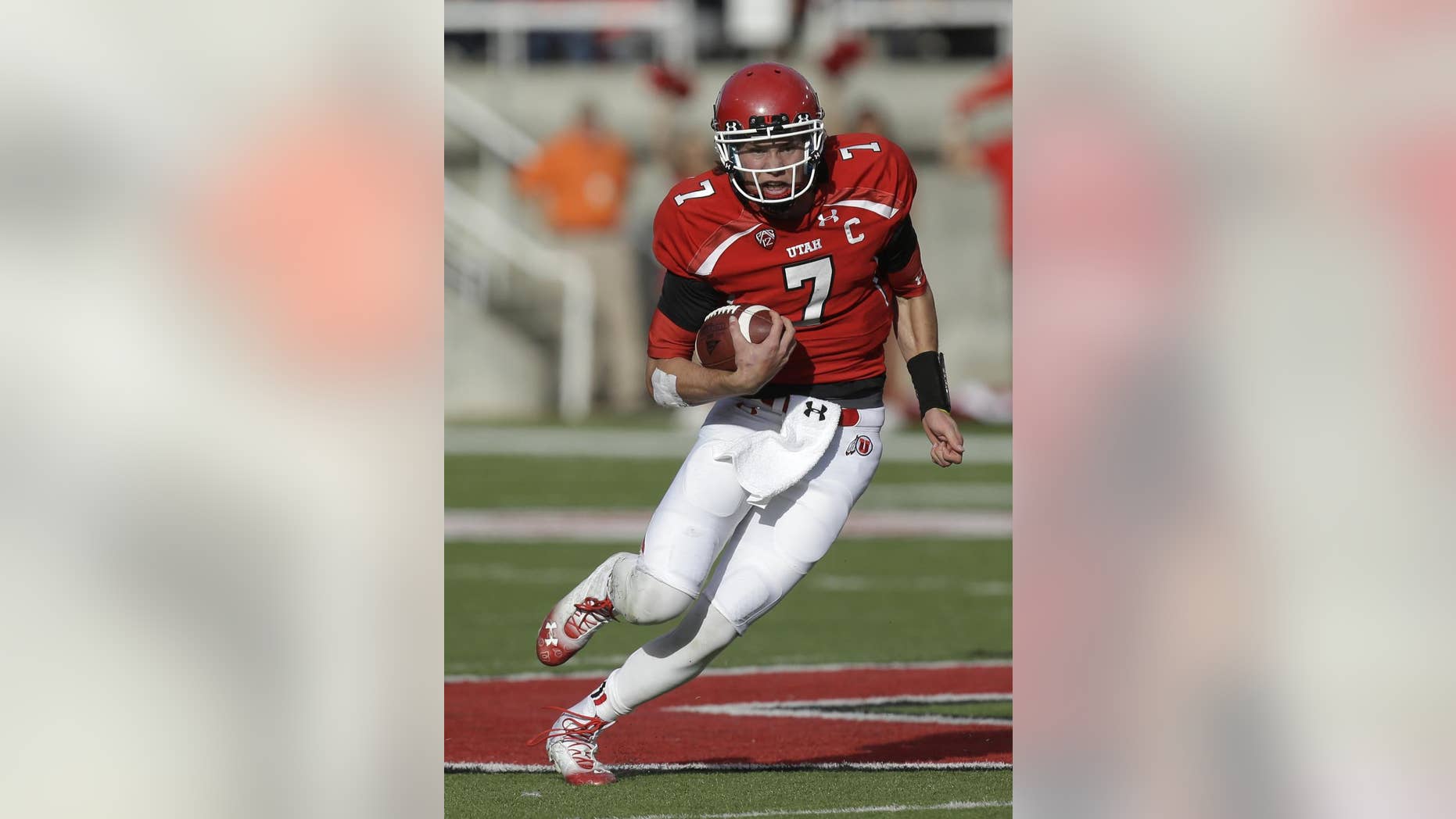 FILE - In this Nov. 9, 2013, file photo, Utah quarterback Travis Wilson carries the ball during an NCAA college football game against Arizona State in Salt Lake City. Wilson’s first goal this season is to stay healthy. (AP Photo/Rick Bowmer, File)