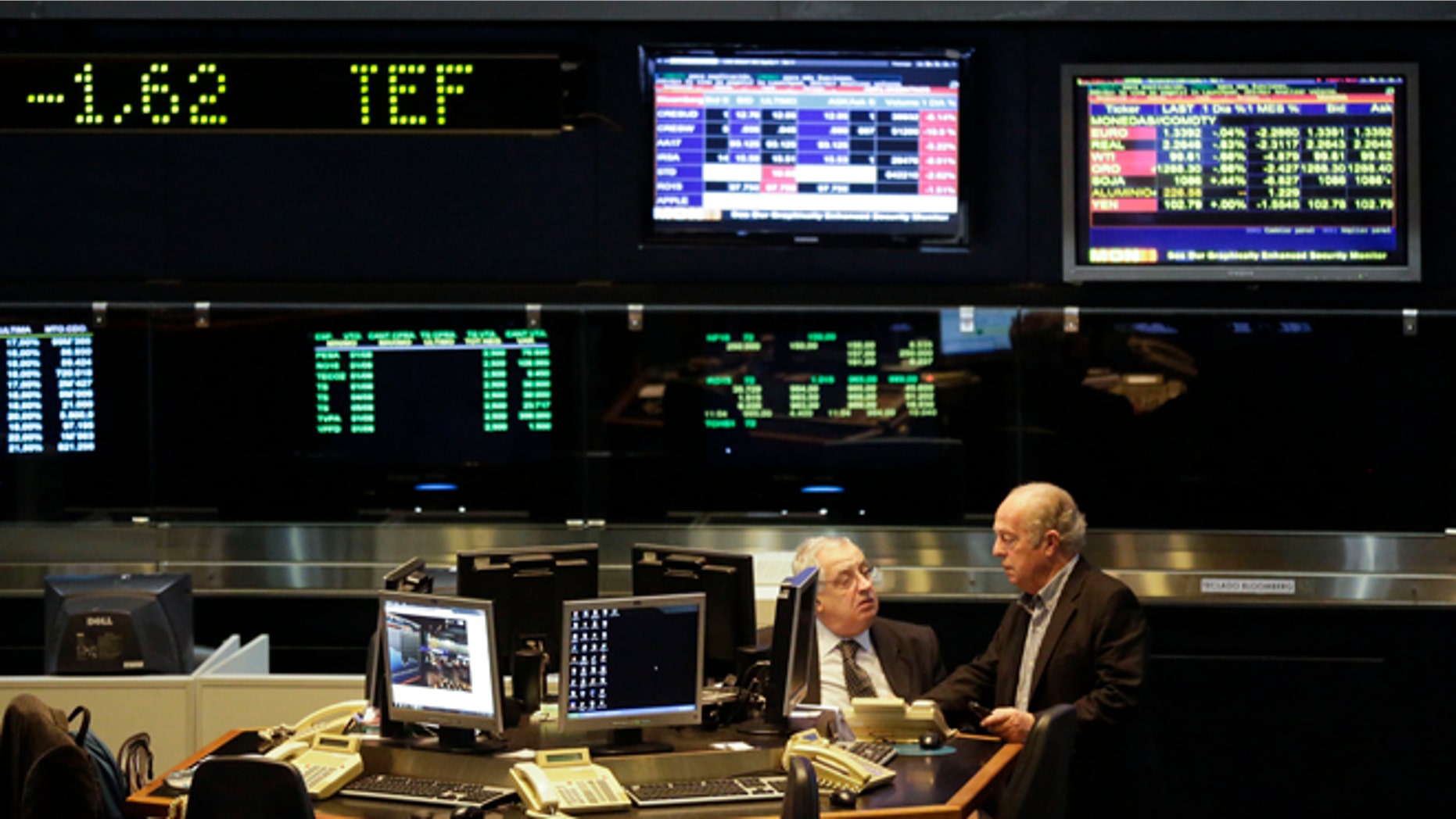 Brokers work at the Buenos Aires Stock Exchange in Buenos Aires, Argentina, Thursday, July 31, 2014. The collapse of talks with U.S. creditors sent Argentina into its second debt default in 13 years and raised questions about what comes next for financial markets and the South American nation's staggering economy. (AP Photo/Victor R. Caivano)