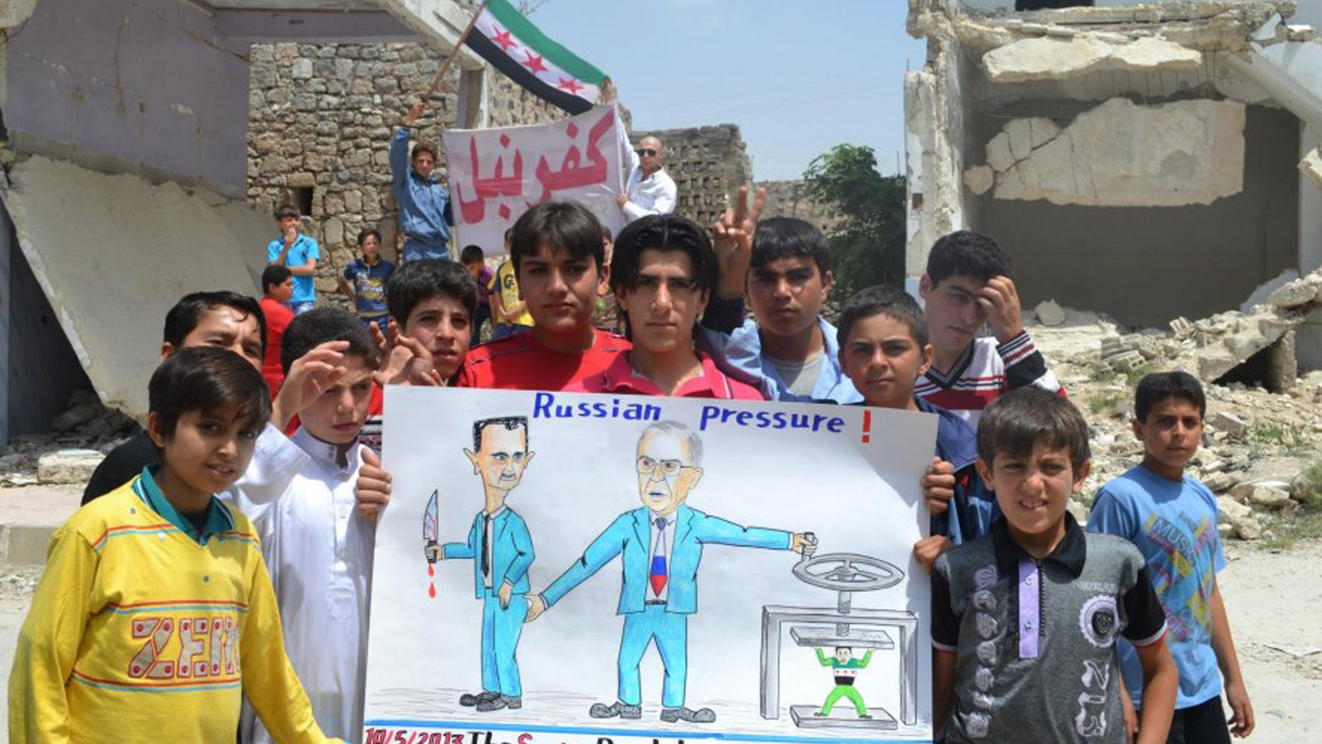 In this citizen journalism image provided by Edlib News Network, ENN, which has been authenticated based on its contents and other AP reporting, anti-Syrian regime protesters hold a poster depicting Syrian President Bashar Assad, left, and Russian Foreign Minister Sergei Lavrov, right, during a demonstration, at Kafr Nabil town, in Idlib province, northern Syria, Friday May 10, 2013. Arabic banner on the background reads, "Kafr Nabil." (AP Photo/Edlib News Network ENN)