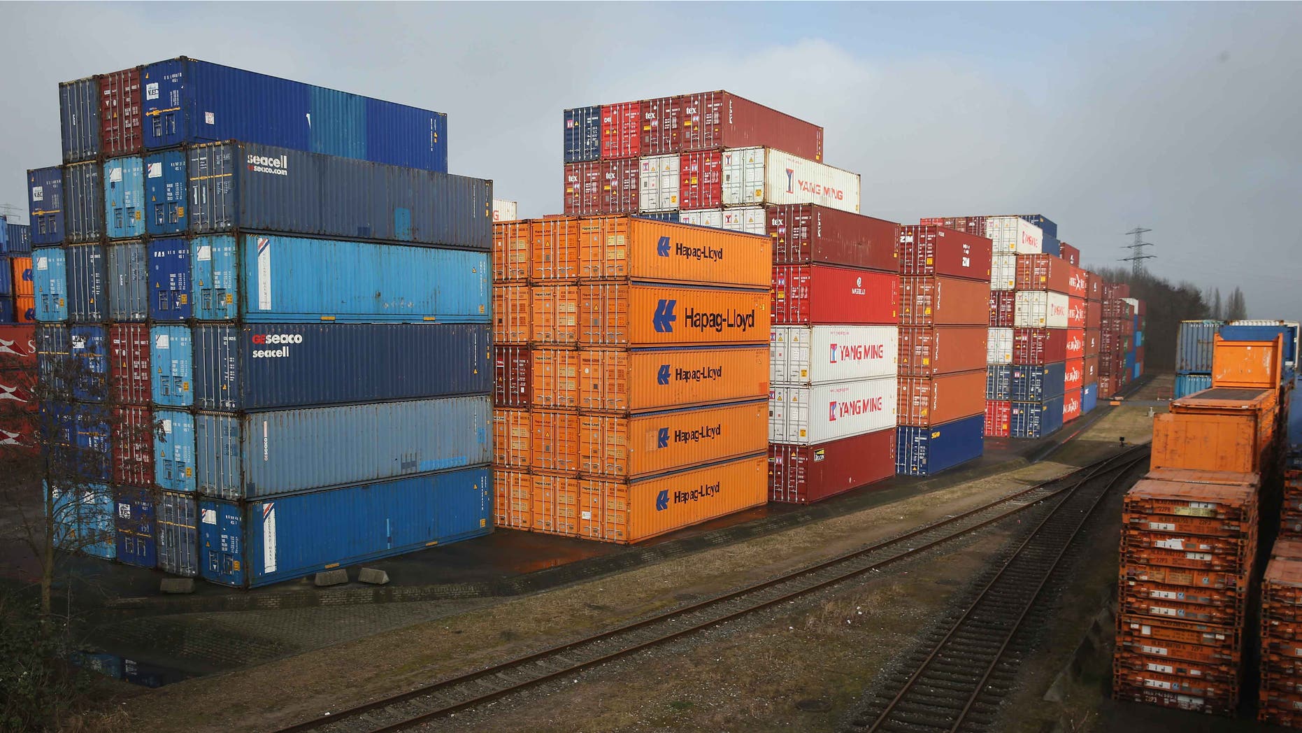 HAMBURG, GERMANY - MARCH 04: Stacked shipping containers stand next to railway lines at a terminal at Hamburg Port on March 4, 2016 in Hamburg, Germany. According to the most recent data Germany has the highest trade surplus in the world, at EUR 285 billion for 2014. Its major exports include cars and other vehicles, as well as machinery, chemicals and pharmaceuticals. (Photo by Sean Gallup/Getty Images)