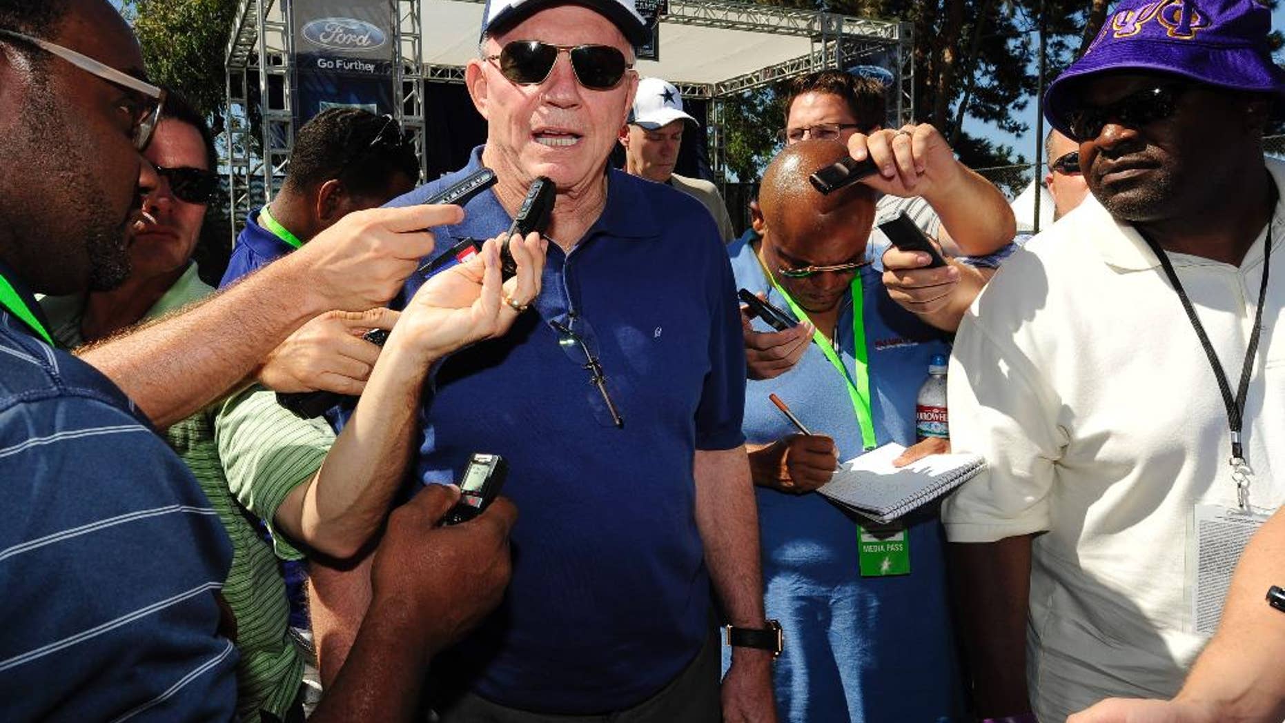 File - In this July 23, 2014, file photo, Dallas Cowboys owner Jerry Jones talks with the media at the conclusion of the "State of the team" news conference during Dallas Cowboy's training camp, in Oxnard, Calif. An Oklahoma woman accuses Jones in a lawsuit of paying her for at least four years to keep her from reporting an alleged sexual assault. A hearing on whether the lawsuit should be dismissed is scheduled for Friday, Sept. 26 in Dallas. (AP Photo/Gus Ruelas, File)