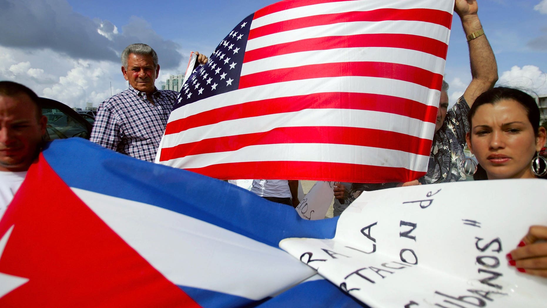 MIAMI - JULY 11: Oridio Conde (L) and Laura Hernandez participate in a protest July 11, 2006 in Miami, Florida. The protest was being held by relatives and friends of the Cubans involved in this past weekend?s interdiction at sea by the U.S. Coast Guard. They want the U.S. government to allow their relatives who are being held on a Coast Guard cutter to be allowed into the United States. One person died and four others were injured when their boat ignored orders to stop by the Coast Guard. (Photo by Joe Raedle/Getty Images)