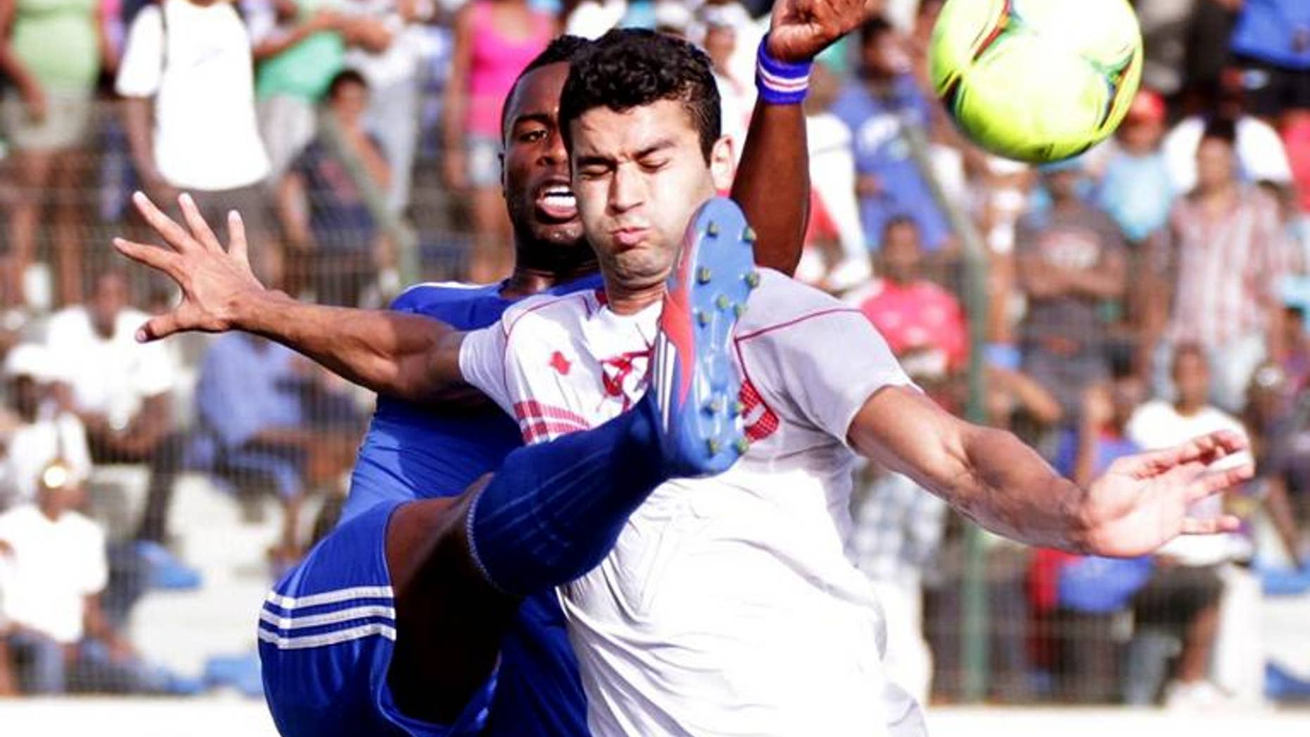 Tunisian stirker Hamdi Harbaoui vies with Cape Verdean defender Fernando Varela (left) in Praia Stadium during qualifying match for the 2014 FIFA World Cup on June 9, 2012