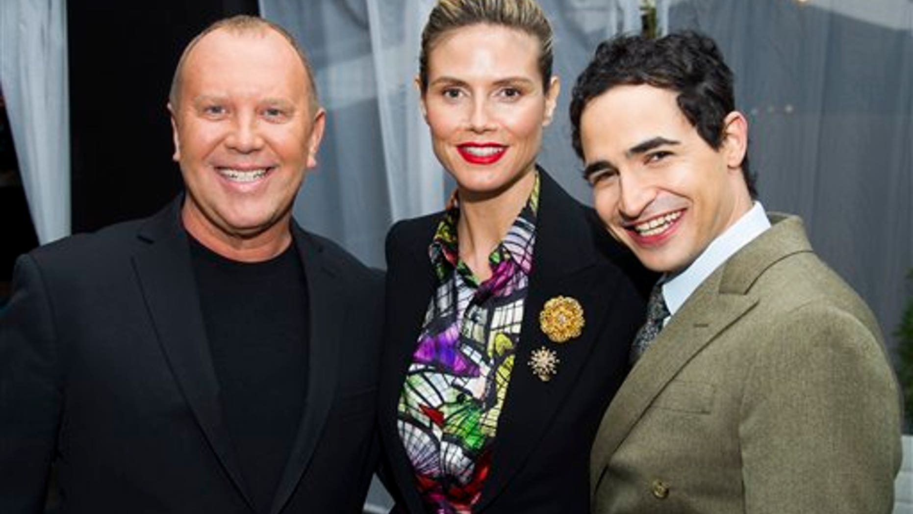Michael Kors, from left, Heidi Klum and Zac Posen pose before the Fall 2013 Project Runway fashion show on Friday, Feb. 8, 2013 in New York. (Photo by Charles Sykes/Invision/AP)