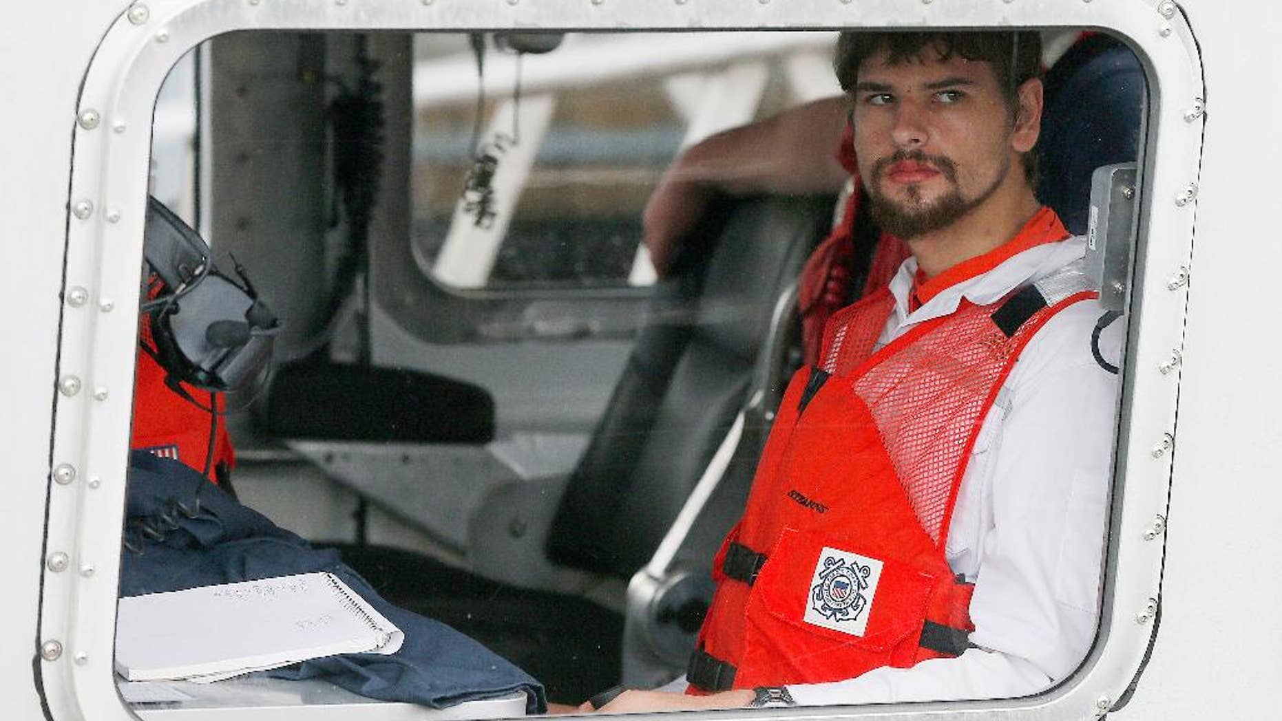 FILE- In this Sept. 27, 2016, file photo, Nathan Carman arrives in a small boat at the US Coast Guard station in Boston. Carman spent a week at sea in a life raft before being rescued by a passing freighter. Police have returned to the home of a man whose 2013 killing remains unsolved and whose daughter is presumed dead after she went out sailing with her son, Nathan Carman, and their boat sank this year. (AP Photo/Michael Dwyer, File)