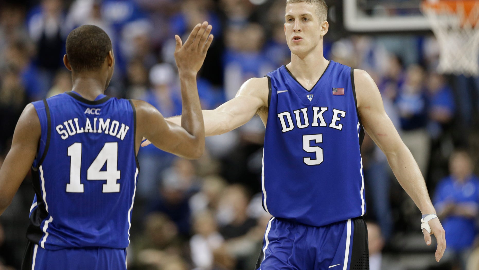 Duke's Mason Plumlee (5) is congratulated by teammate Rasheed Sulaimon (14) during the second half of an NCAA college basketball game against Wake Forest in Winston-Salem, N.C., Wednesday, Jan. 30, 2013. Duke won 75-70. (AP Photo/Chuck Burton)