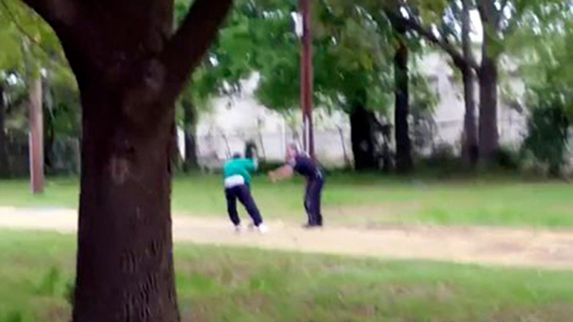 In this image from video, Walter Scott struggles with police officer Michael Thomas Slager in Charleston, S.C., on April 4, 2015. Moments later, the video shows Slager firing eight shots at Scott's back. Scott's death was shown around the world and he became a symbol of the ongoing debate over police shootings of unarmed African-Americans. (Feidin Santana via AP Images)