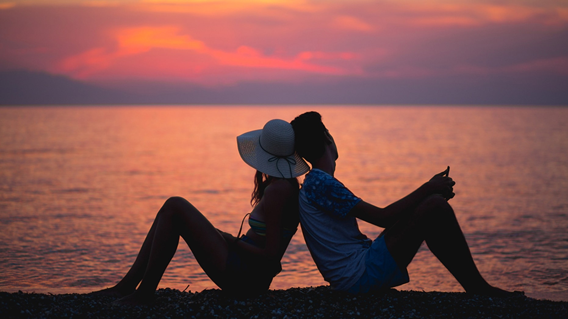 couple watching sunset on the beach