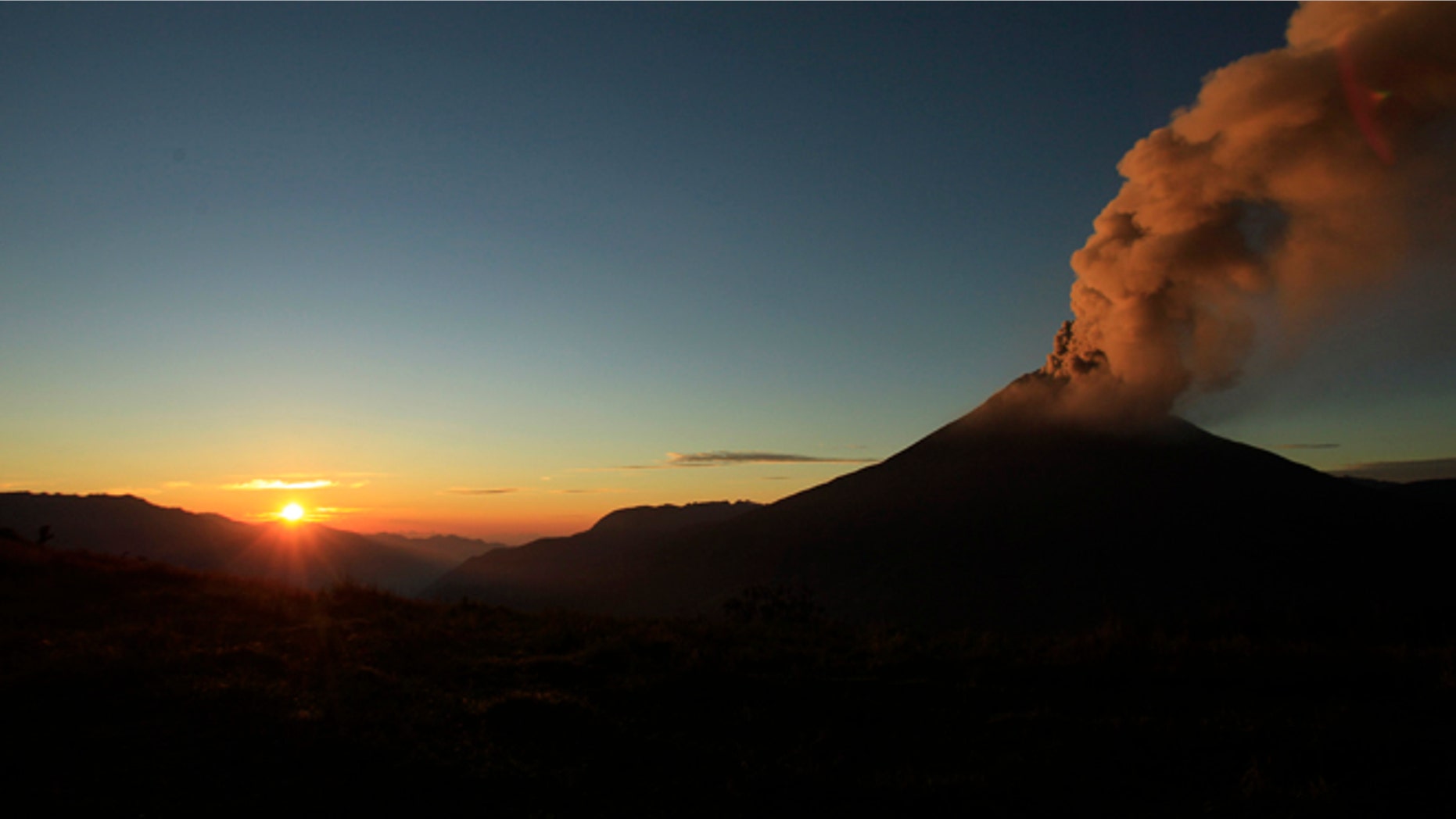 Ash and steam billow from the Tungurahua volcano, seen from Huambalo, Ecuador, as the sun rises early Tuesday, Aug. 21, 2012. (AP Photo/Dolores Ochoa)