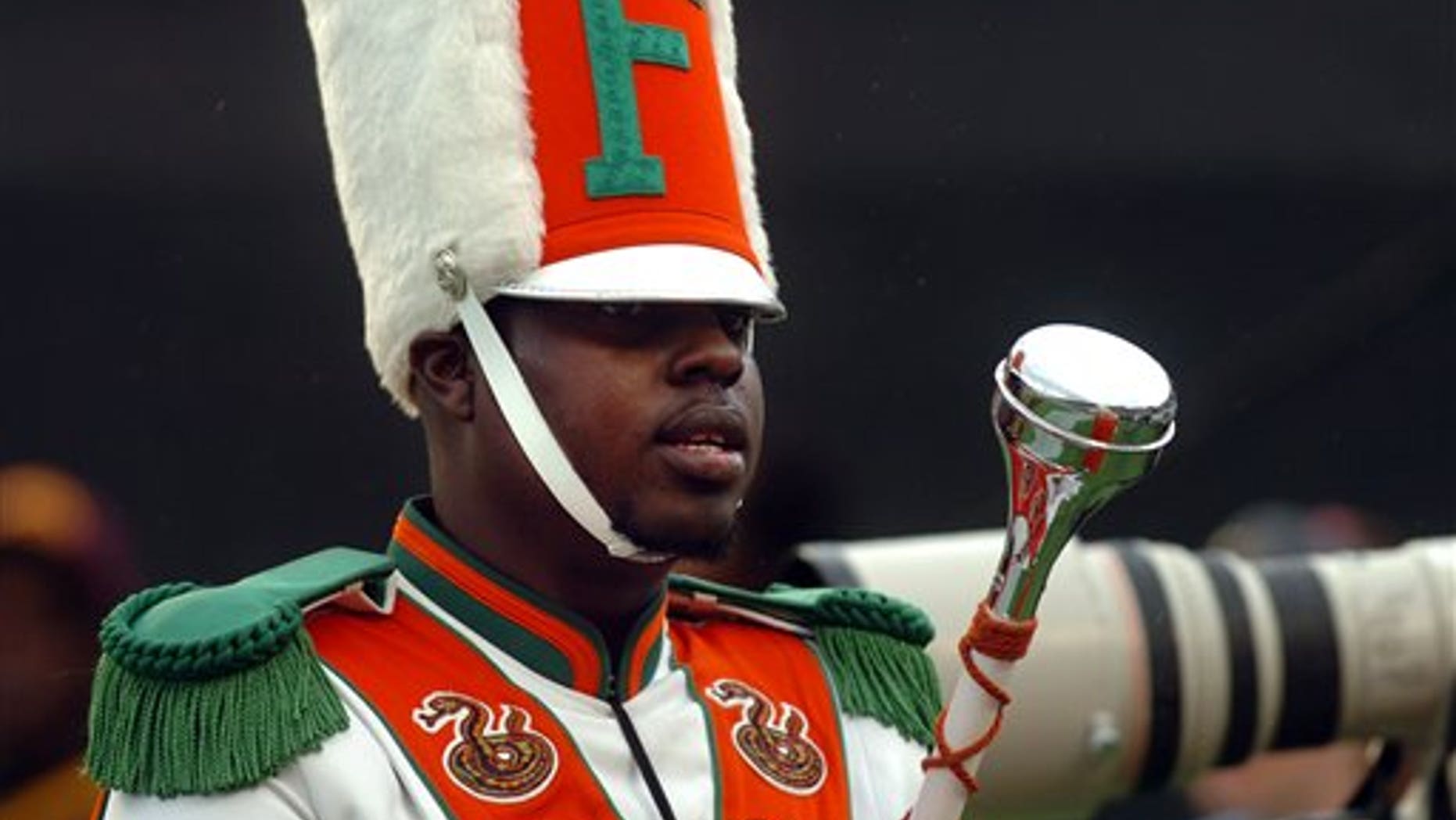 In this Nov. 19, 2011 file photo, Robert Champion, a drum major in Florida A&M University's Marching 100 band, performs during halftime of a football game in Orlando, Fla. Champion, who died after being hazed on a bus, asked to go through the ordeal because it was seen as an honor, said defendant Jonathan Boyce in a deposition released Wednesday, May 23, 2012.