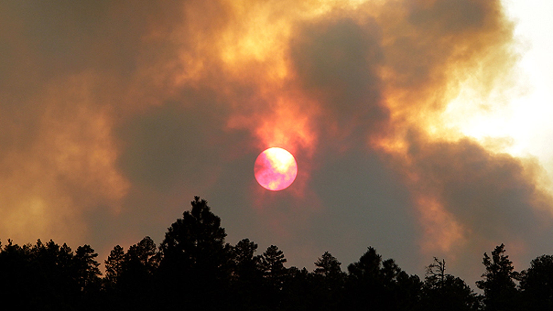 June 14: The sun sets behind smoke from the Wallow fire in Luna, N.M. The focus of the battle against the massive wildfire burning in eastern Arizona was on New Mexico as crews continued to light fires around the town of Luna to stop the flames.
