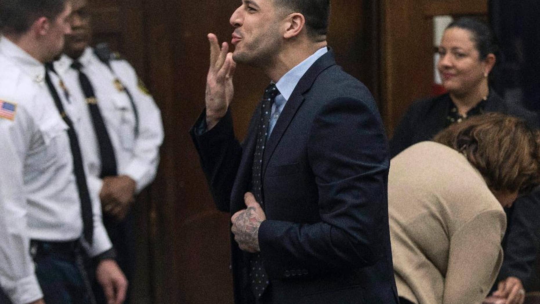 FILE - In this Wednesday, April 12, 2017, file photo, former New England Patriots tight end Aaron Hernandez blows a kiss to his daughter, who sat with her mother, Shayanna Jenkins Hernandez, Hernandez's longtime fiancee, during jury deliberations in his double-murder trial at Suffolk Superior Court in Boston. Hernandez was acquitted of those crimes on Friday, but hanged himself in his prison early Wednesday, April 19, 2017, where he was serving a life sentence in the 2013 killing of semi-professional football player Odin Lloyd. (Keith Bedford /The Boston Globe via AP, Pool, File)