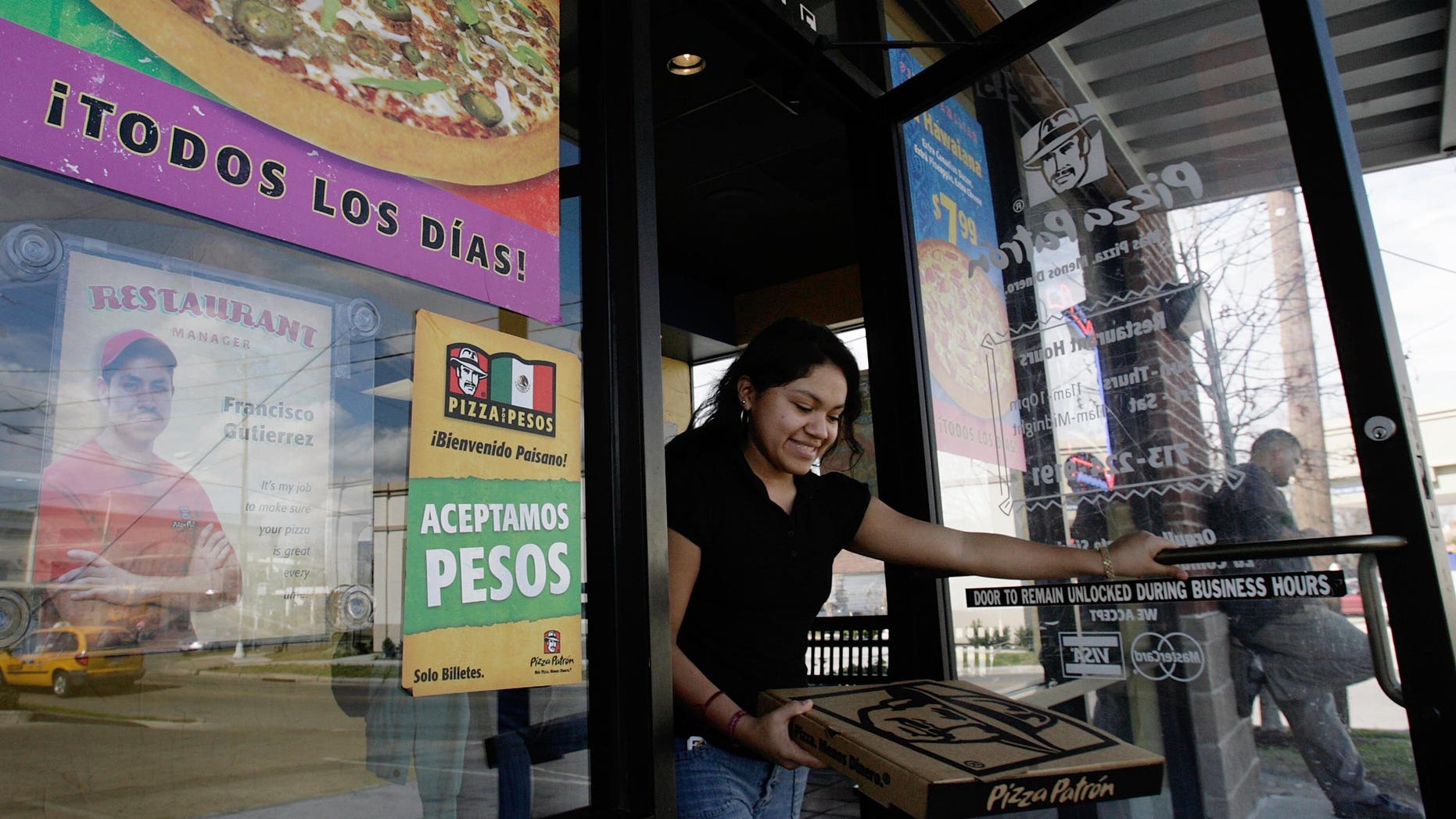 HOUSTON, TX - JANUARY 12: A customer leaves a Pizza Patron January 12, 2007, in Houston. The pizza chain now accepts Mexican pesos and U.S. dollars as payment. (Photo by Dave Einsel/Getty Images)