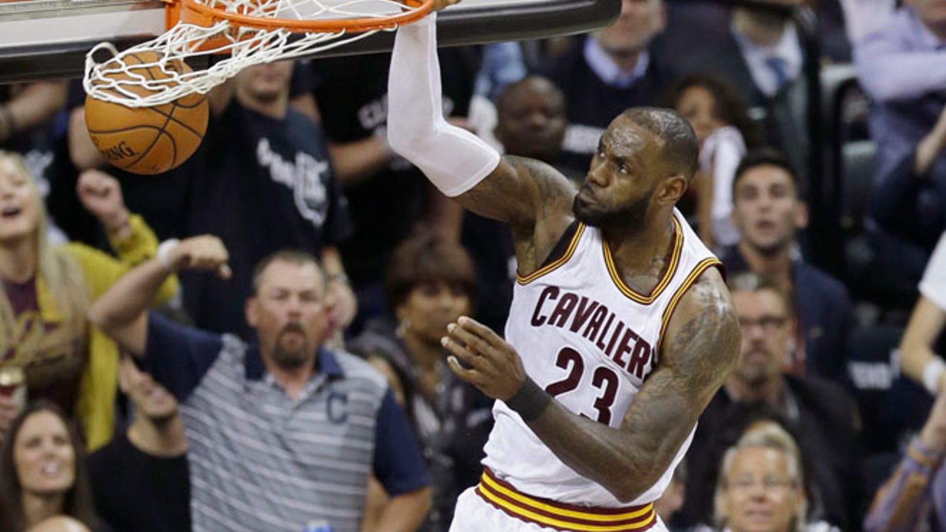 Cleveland Cavaliers forward LeBron James dunks against the Golden State Warriors during the first half of Game 4 of basketball's NBA Finals in Cleveland.