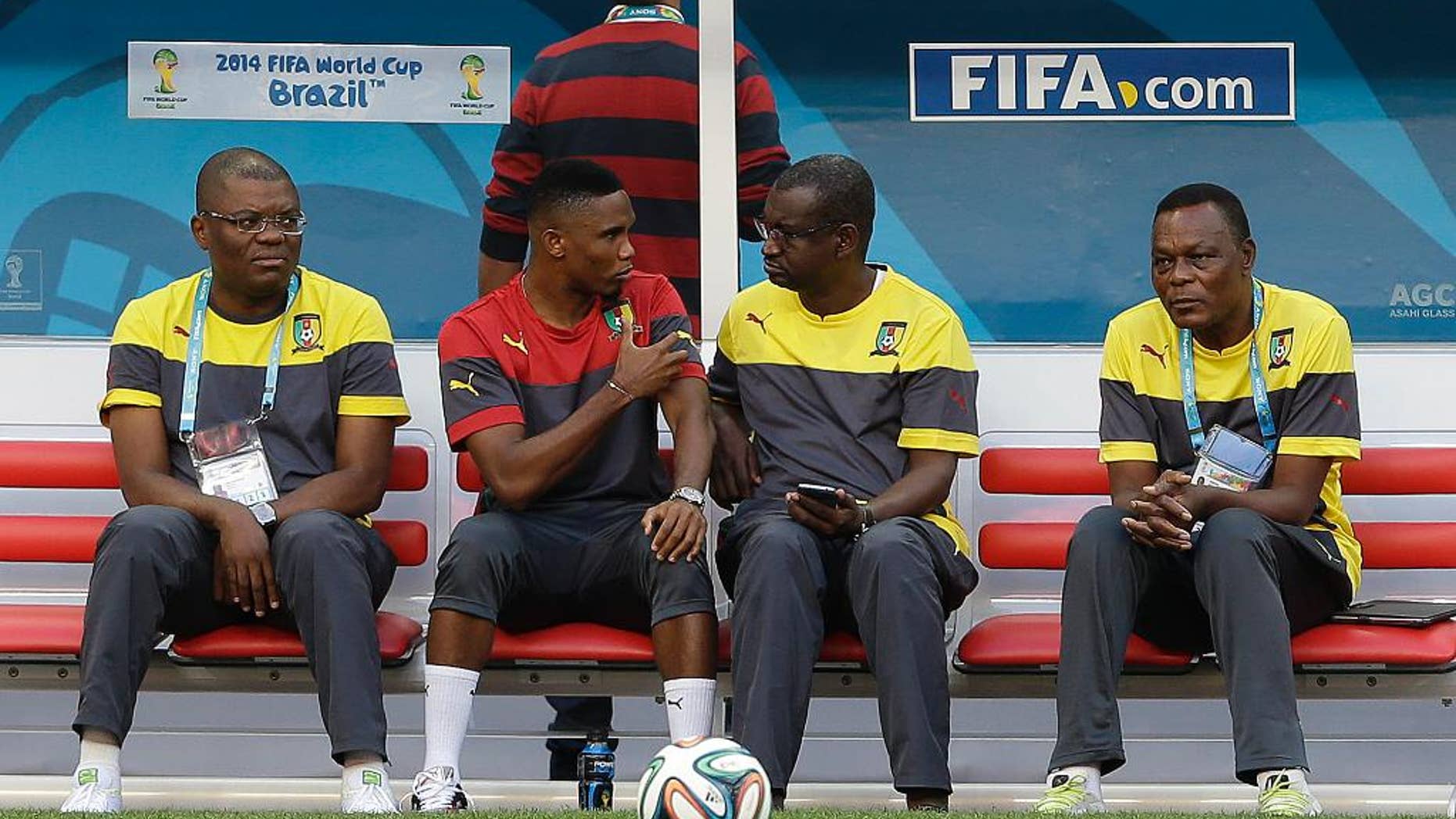 Cameroon's Samuel Eto’o, second from left, talks with a member of his team during an official training session the day before the group A World Cup soccer match between Brazil and Cameroon at the Estadio Nacional in Brasilia, Sunday, June 22, 2014. Cameroon began the tournament with a 1-0 loss to Mexico and a 4-0 defeat to Croatia and they will want to leave the World Cup by beating the hosts. (AP Photo/Andre Penner)