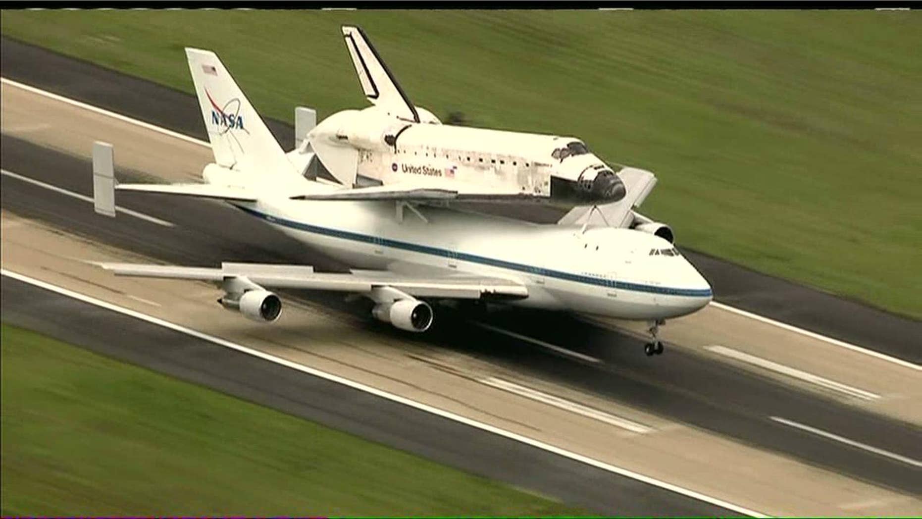 Thousands had packed the National Mall in front of the Capitol to watch the pair swoop by, as Discovery took a leisurely spin at an easy-to-spot 1,500 feet (450 meters) overhead prior to coming to a final rest.