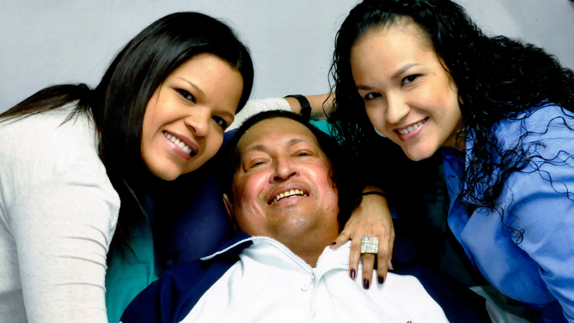In this photo released Friday, Feb. 15, 2013 by Miraflores Presidential Press Office, Venezuela's President Hugo Chavez, center, poses for a photo with his daughters, Maria Gabriela, left, and Rosa Virginia at an unknown location in Havana, Cuba, Thursday, Feb. 14, 2013. Chavez remains in Havana undergoing unspecified treatments following his fourth cancer-related operation on Dec. 11. He has hasn't been seen or spoken publicly in more than two months. (AP Photo/Miraflores Presidential Press Office)