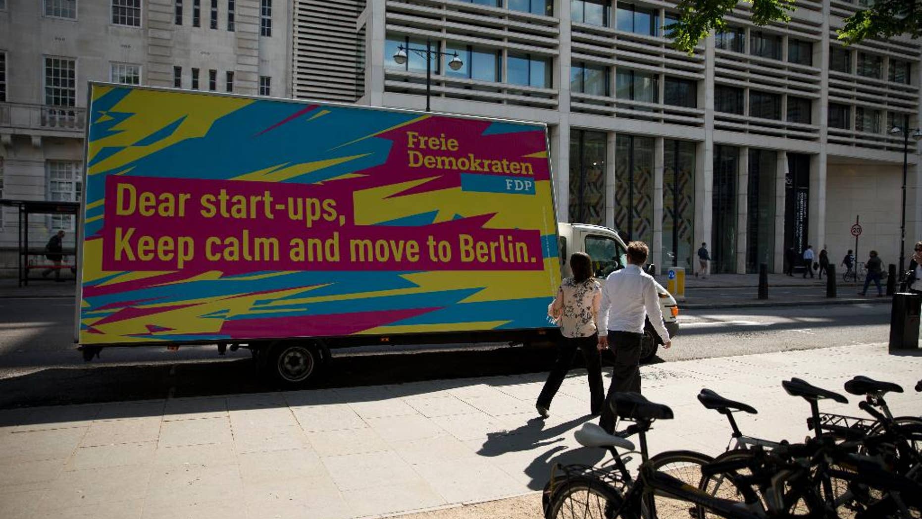 An advert suggesting start-up businesses based in the UK move to Berlin is displayed on a parked vehicle on Finsbury Square in the City of London, Tuesday, July 5, 2016. Its image as a relaxed and relatively affordable city may convince tech companies to relocate to Berlin, which is already home to online retailer Zalando, language-learning service babble and audio sharing platform SoundCloud. Last year, Berlin startups attracted more investment than those in based in London. (AP Photo/Matt Dunham)